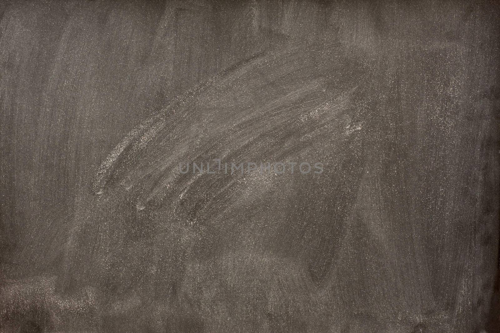 blank blackboard with white smudges from eraser by PixelsAway