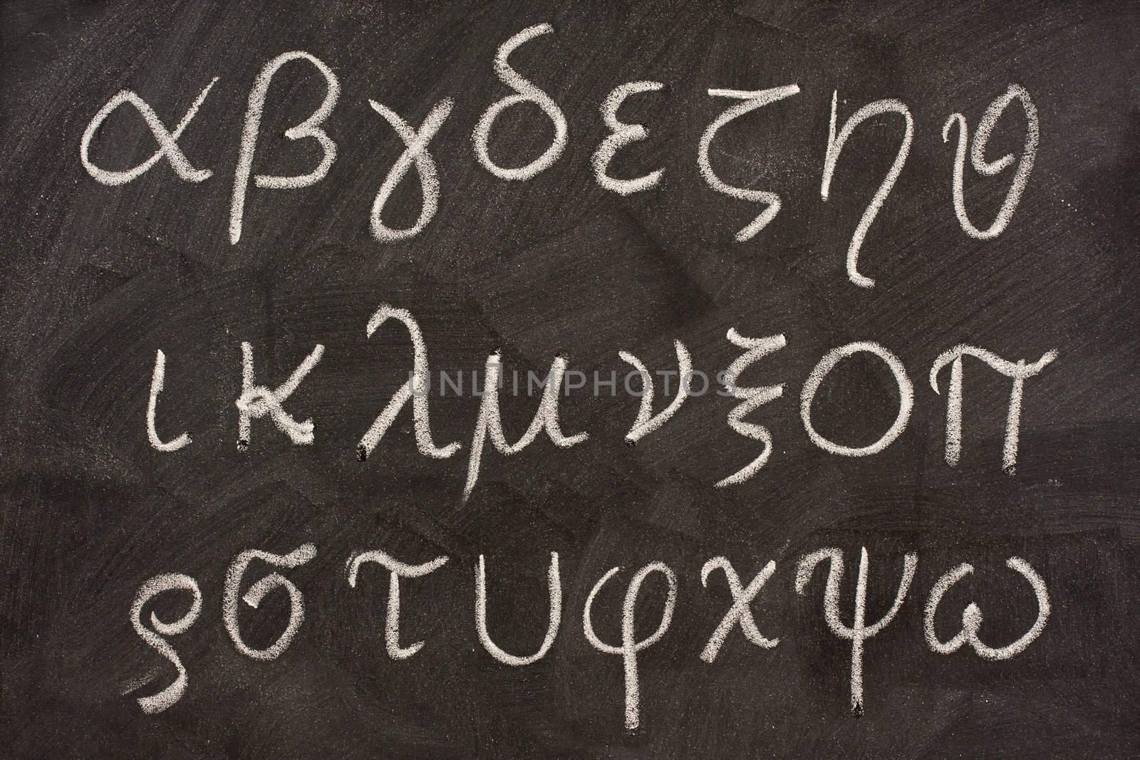 twenty four letters of Greek alphabet from alpha to omega  (in lower case) handwritten with white chalk on a blackboard