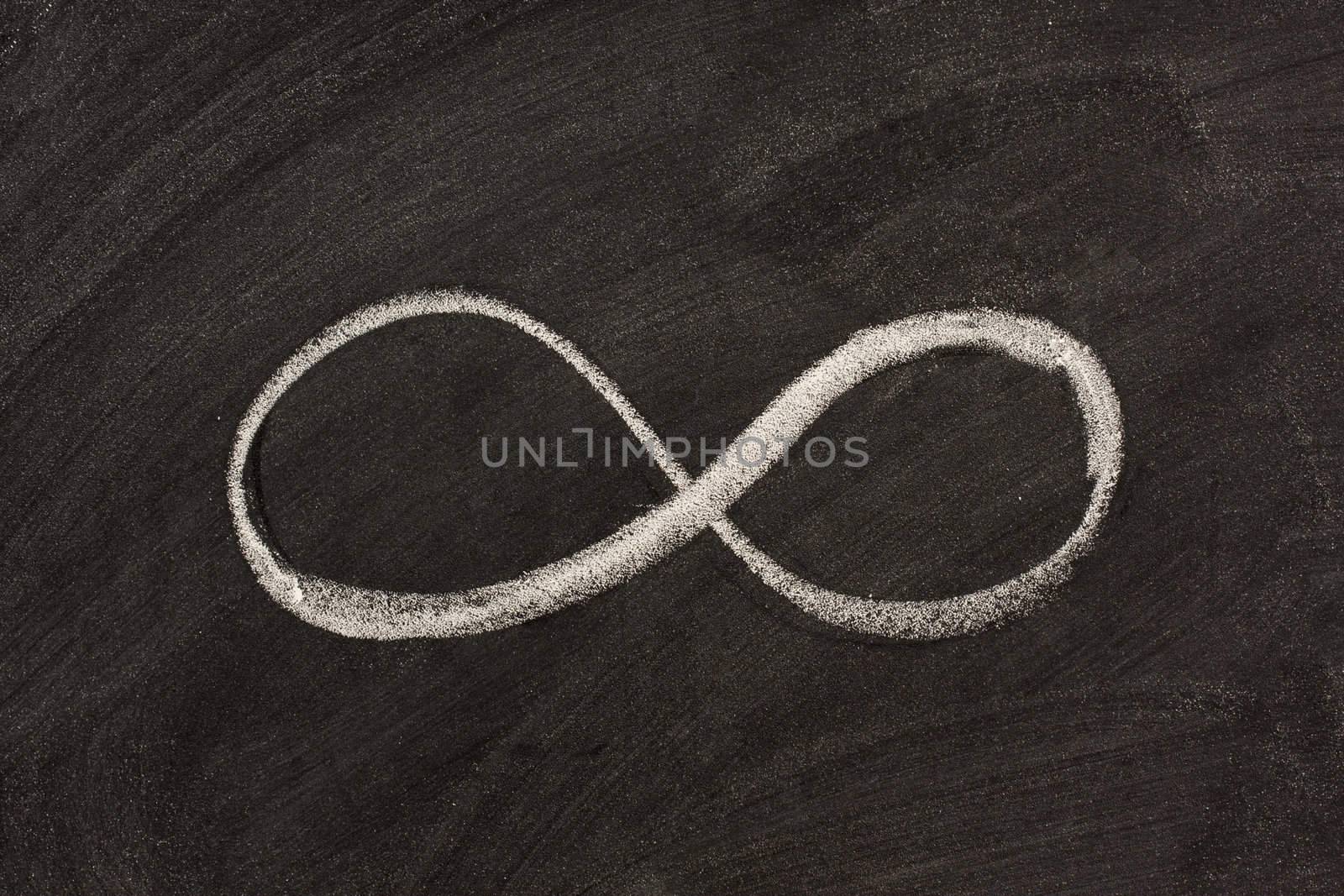infinity symbol on blackboard by PixelsAway