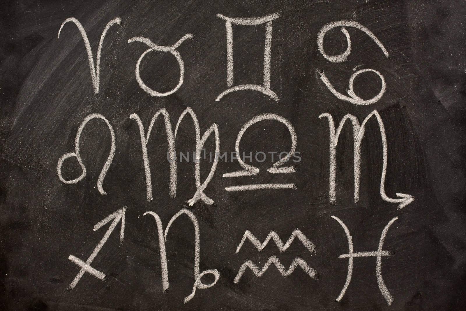 western zodiac symbols on blackboard by PixelsAway