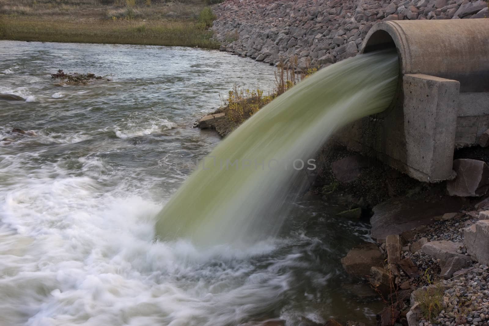 water flowing from a big pipe by PixelsAway