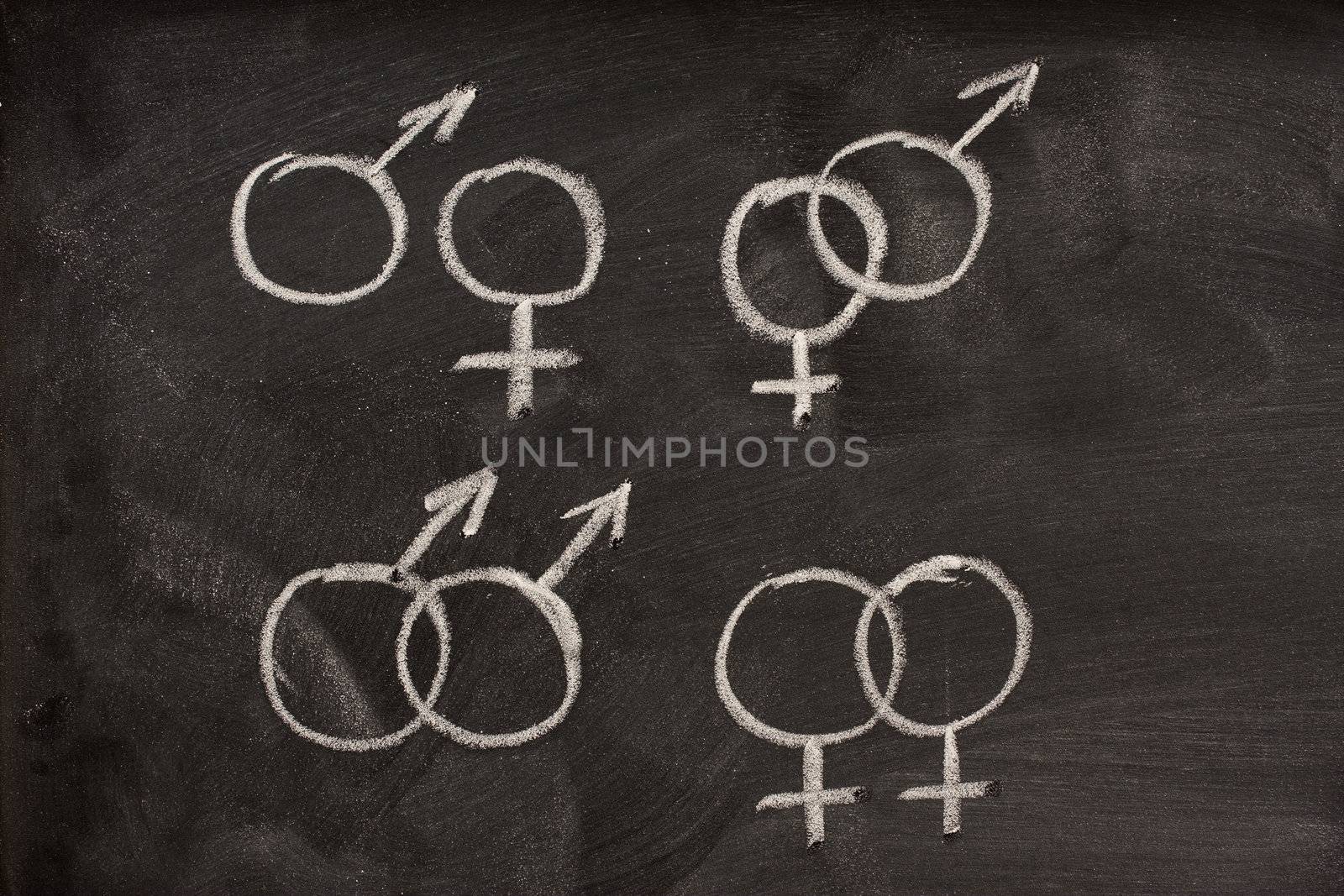 couples of male and female gender symbols on a blackboard by PixelsAway