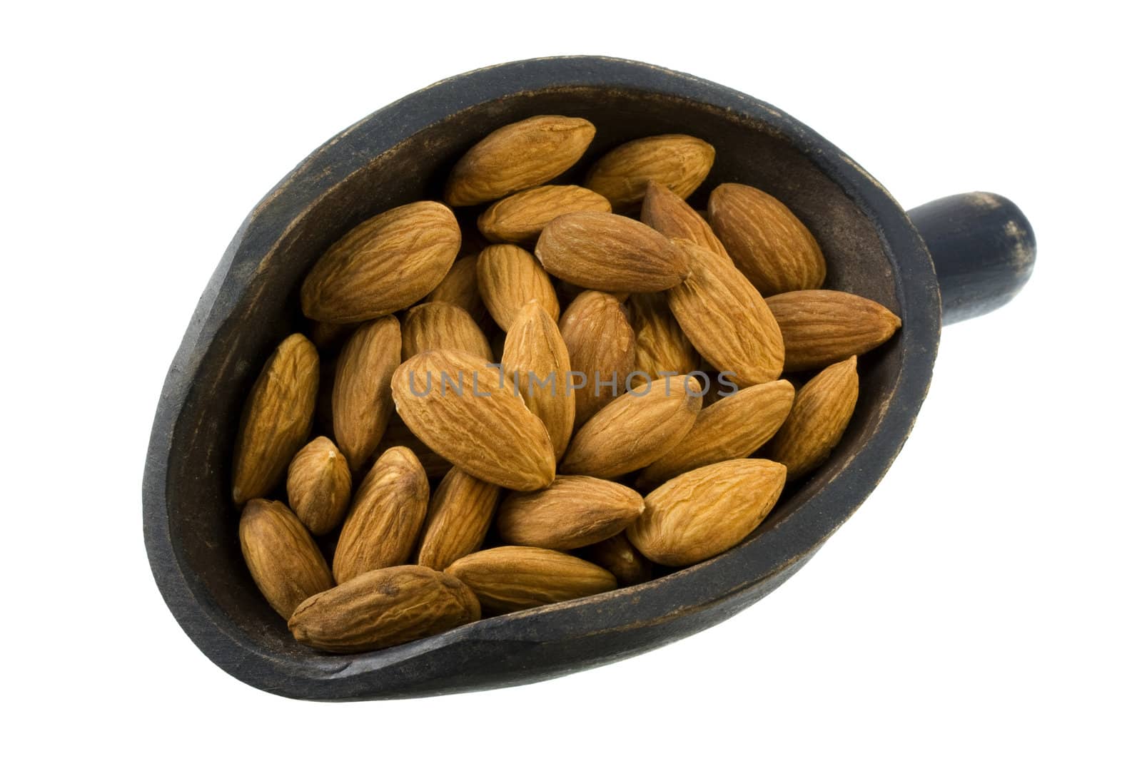 shelled almond nuts on a primitive, wooden, dark painted scoop, isolated on white