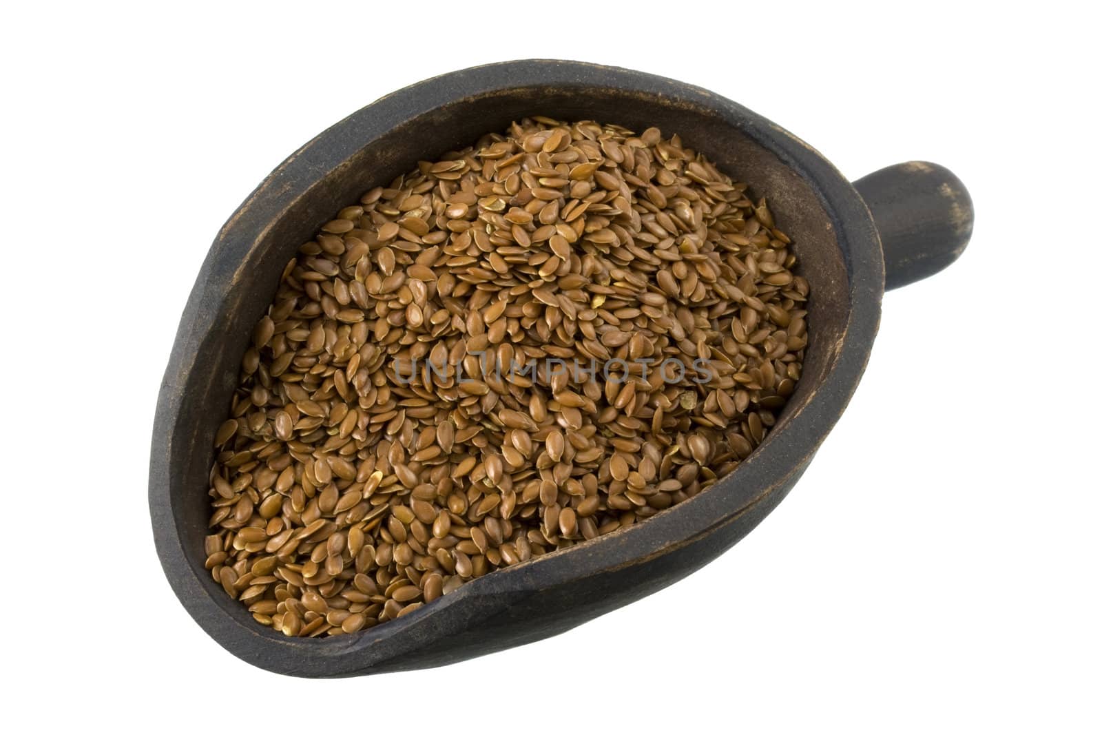 brown flx seeds on a primitive, wooden, dark painted scoop, isolated on white