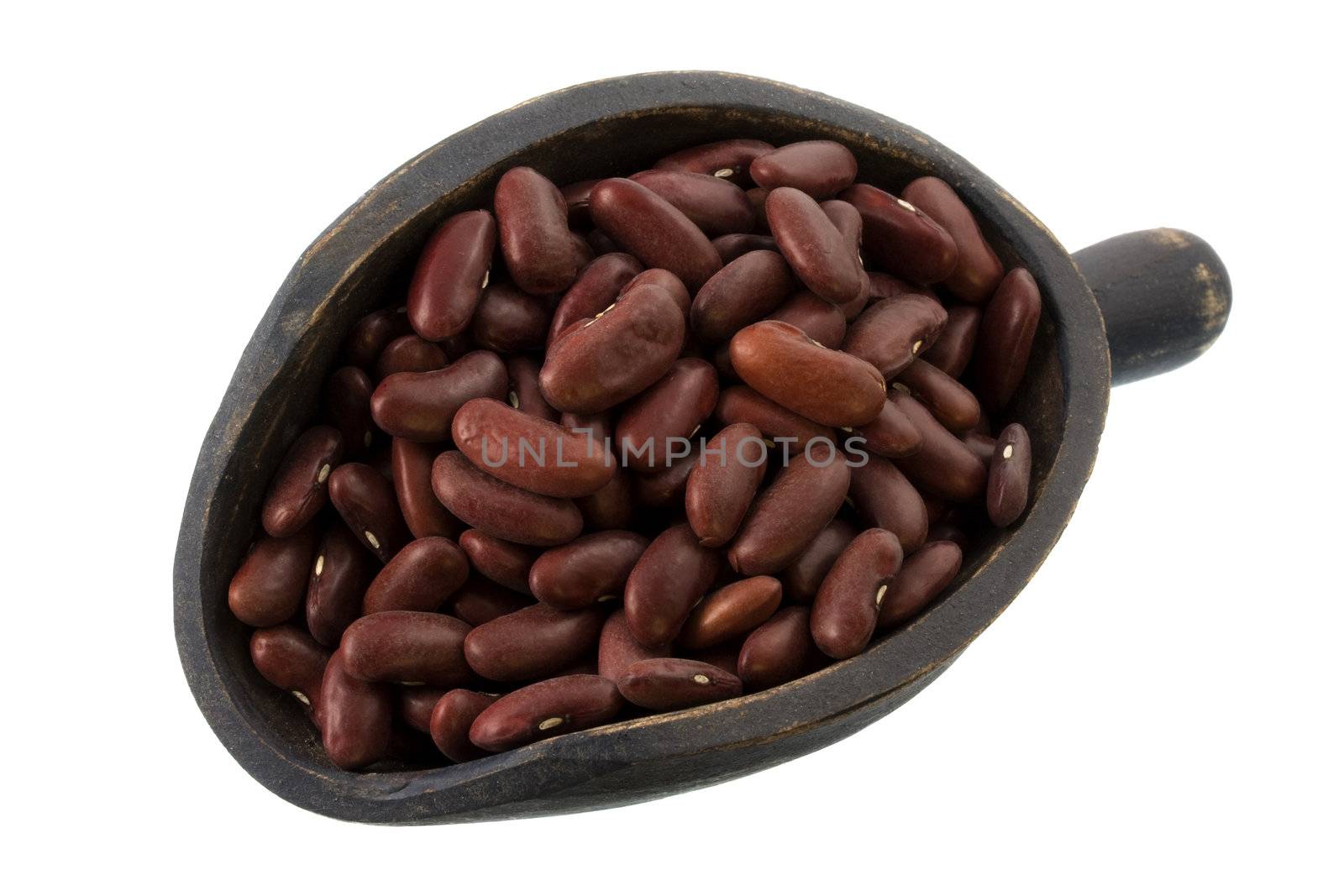 red kidney beans on a primitive, wooden, dark painted scoop, isolated on white