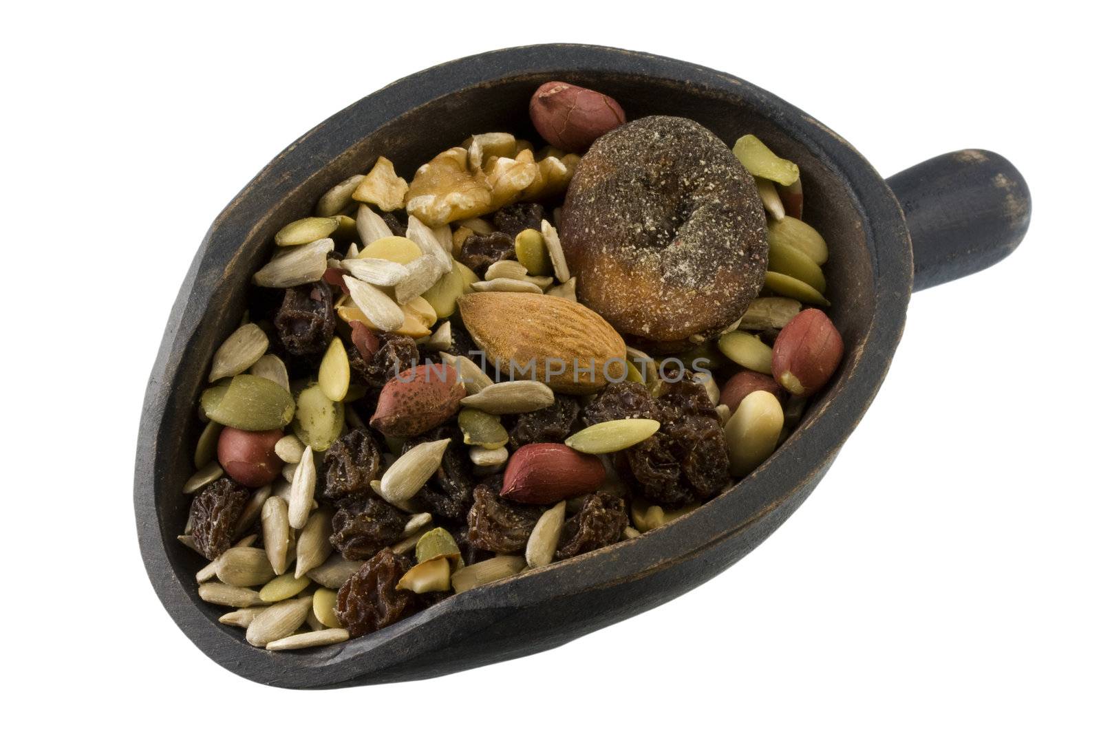 a rustic, wooden scoop of trail mix including sunfkower, pumpkin seeds, peanuts, walnuts, almonds, raisins and figs; isolated with clipping path