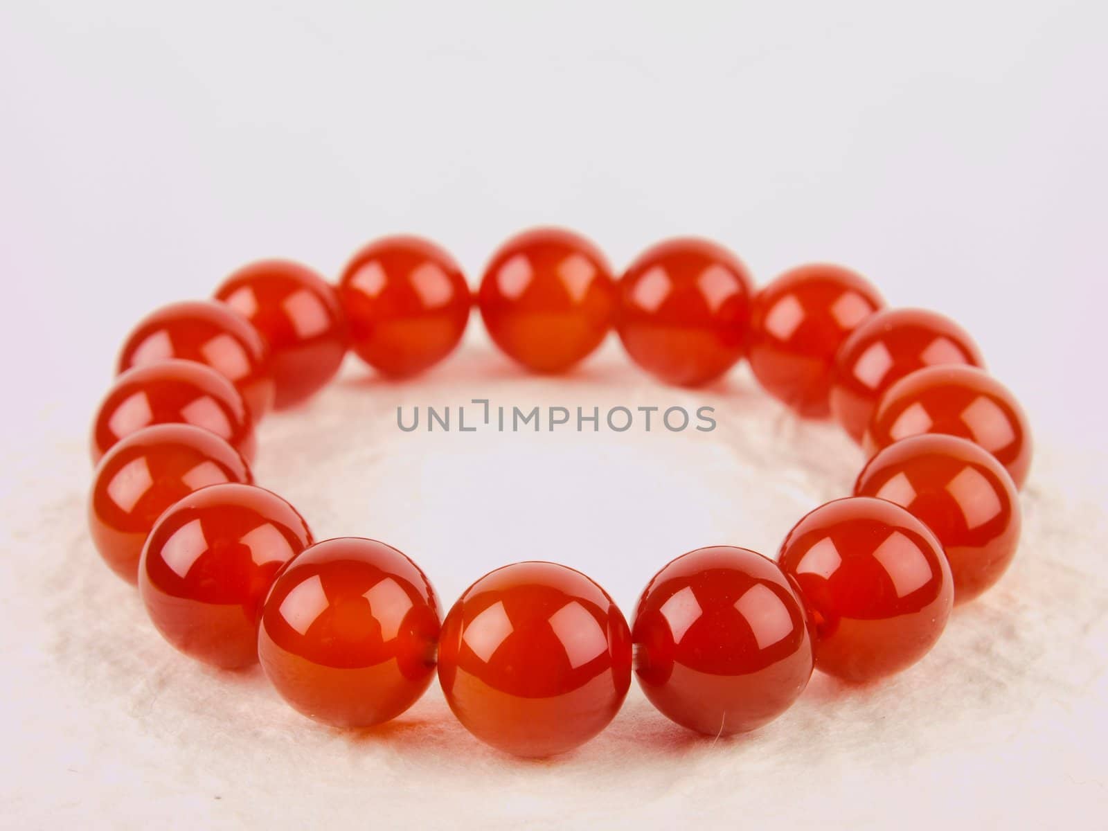Red Chinese bracelet. Close up on white background