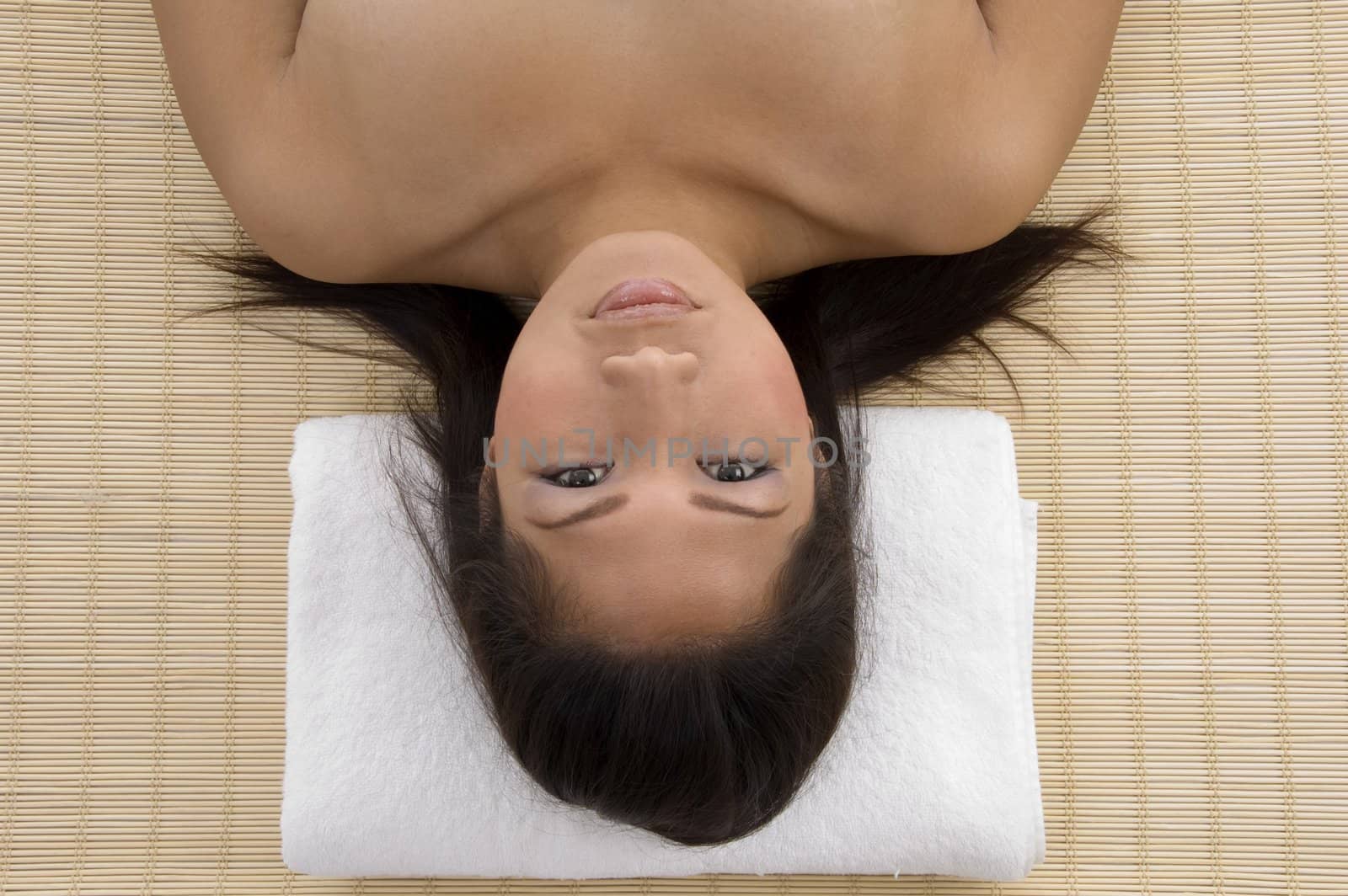 high angle view of laying woman on mat looking at camera