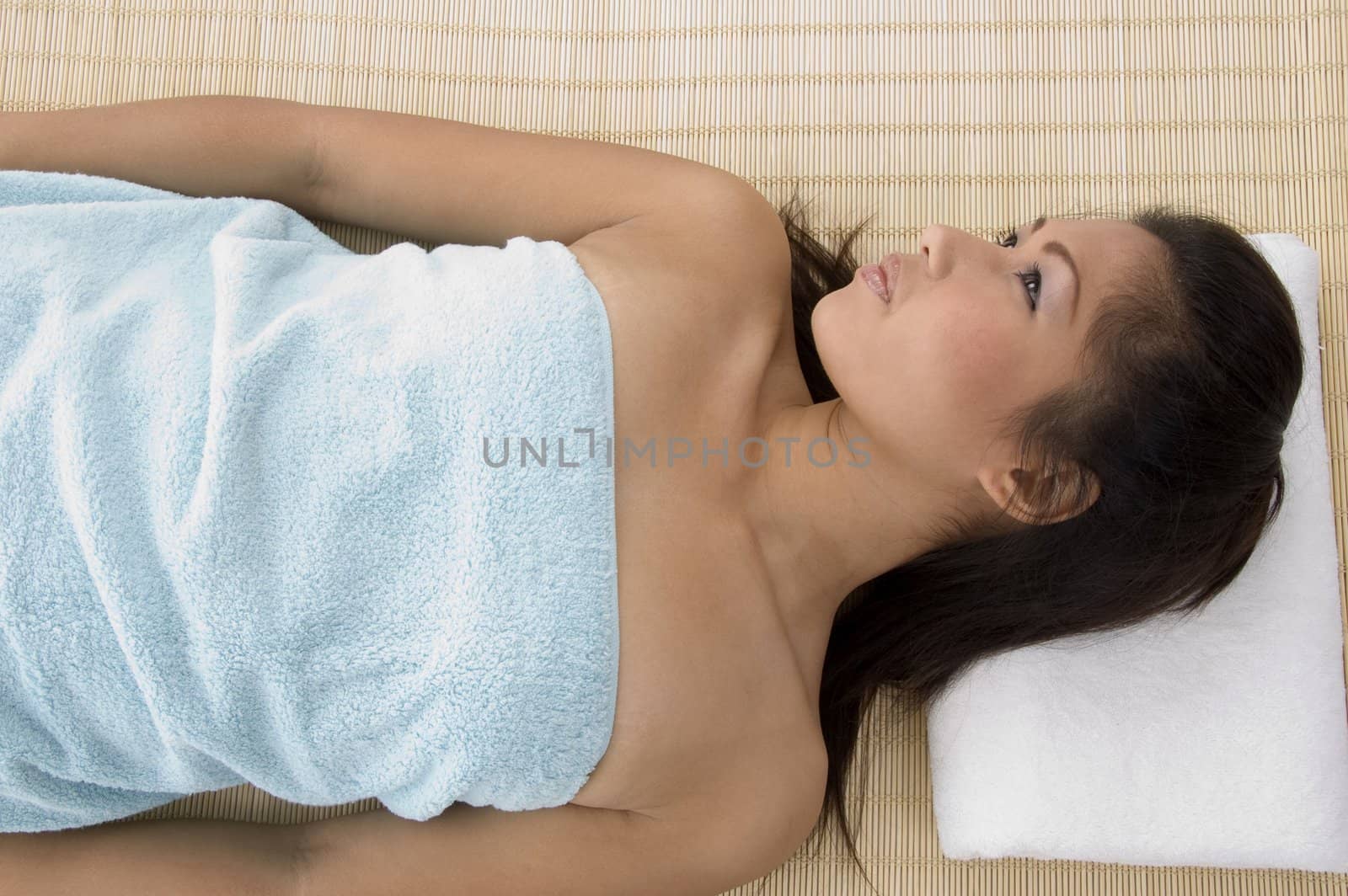 young woman in relaxation pose after taking massage