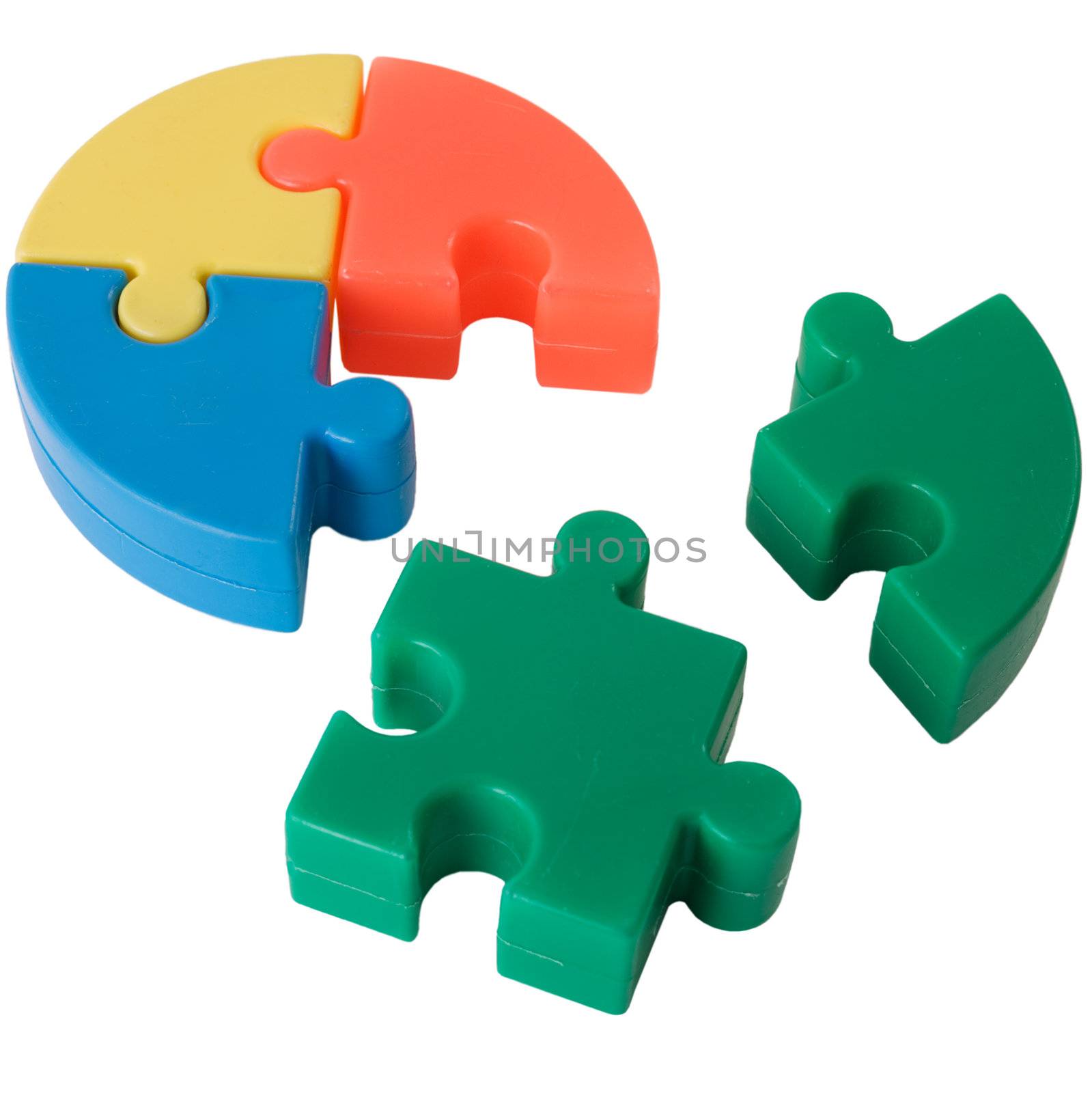 Multi-coloure slices plastic puzzle on the white background