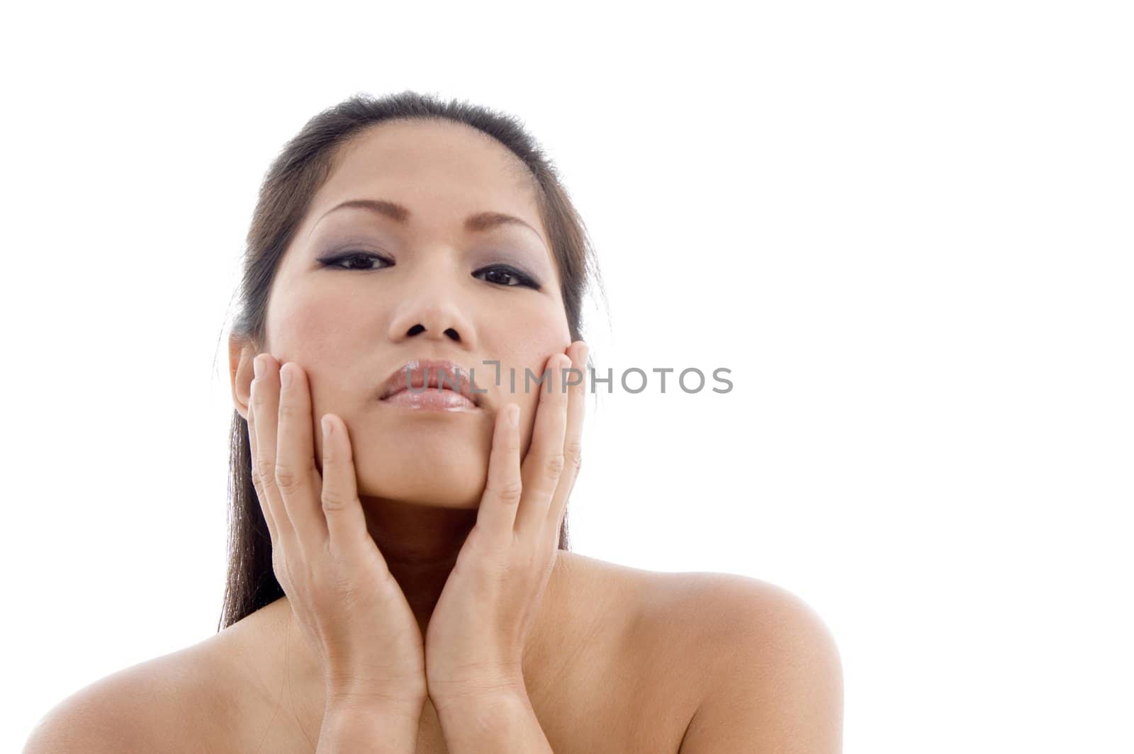close up of beautiful female holding her face with white background