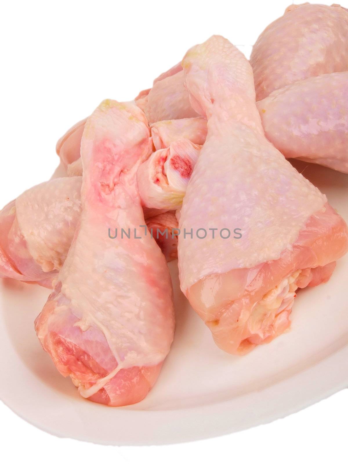 Fresh raw chicken legs. Close up on white background by dotweb