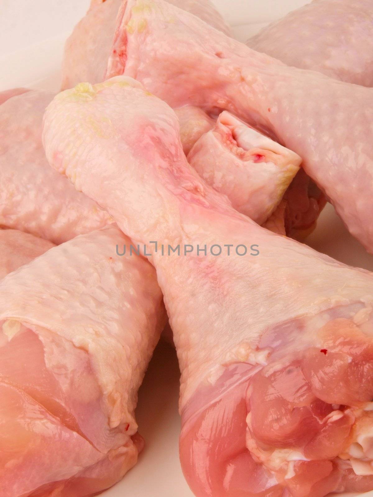 Fresh raw chicken legs. Close up on white background