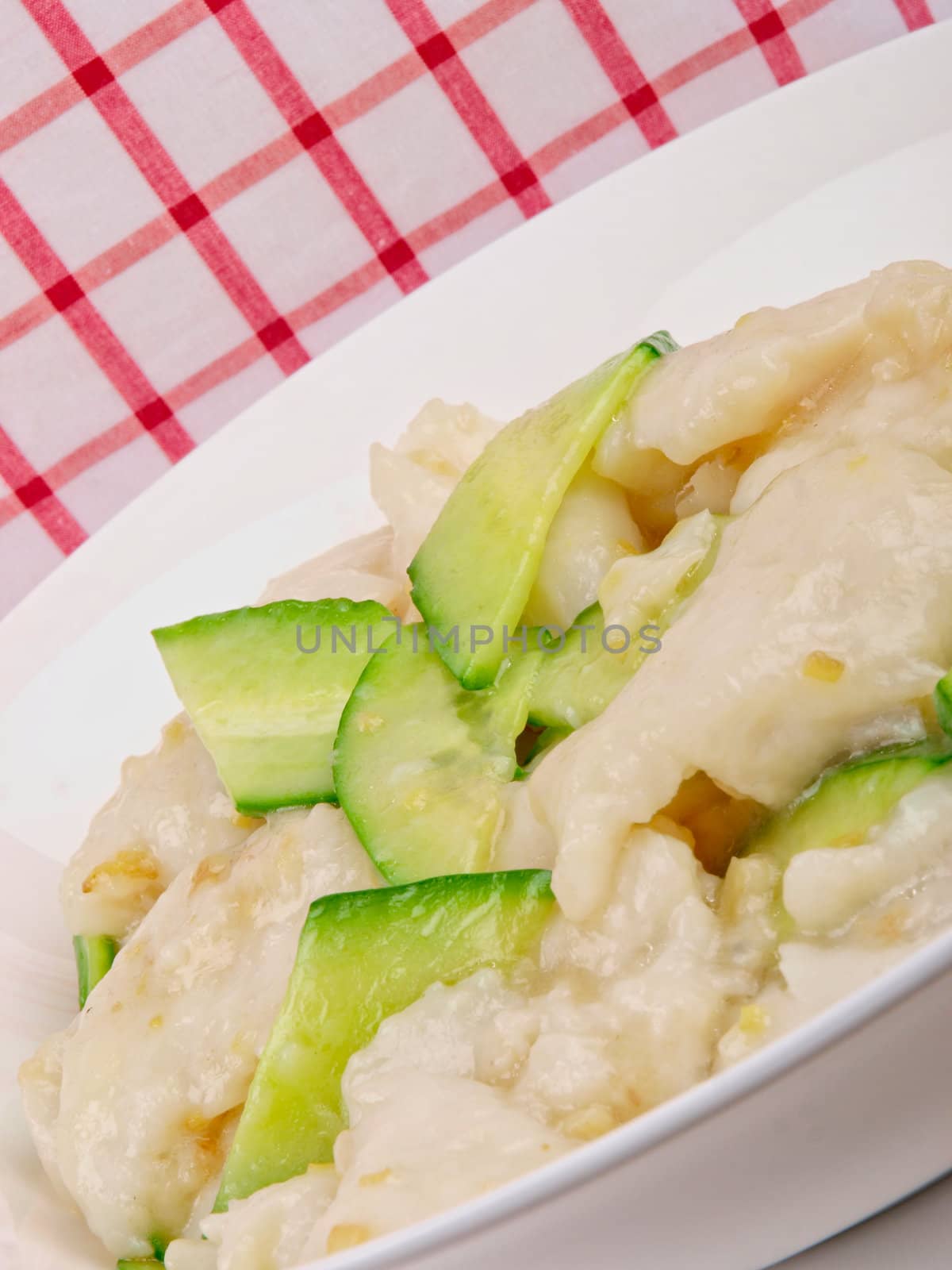 fried white fish with cucumber. Close up