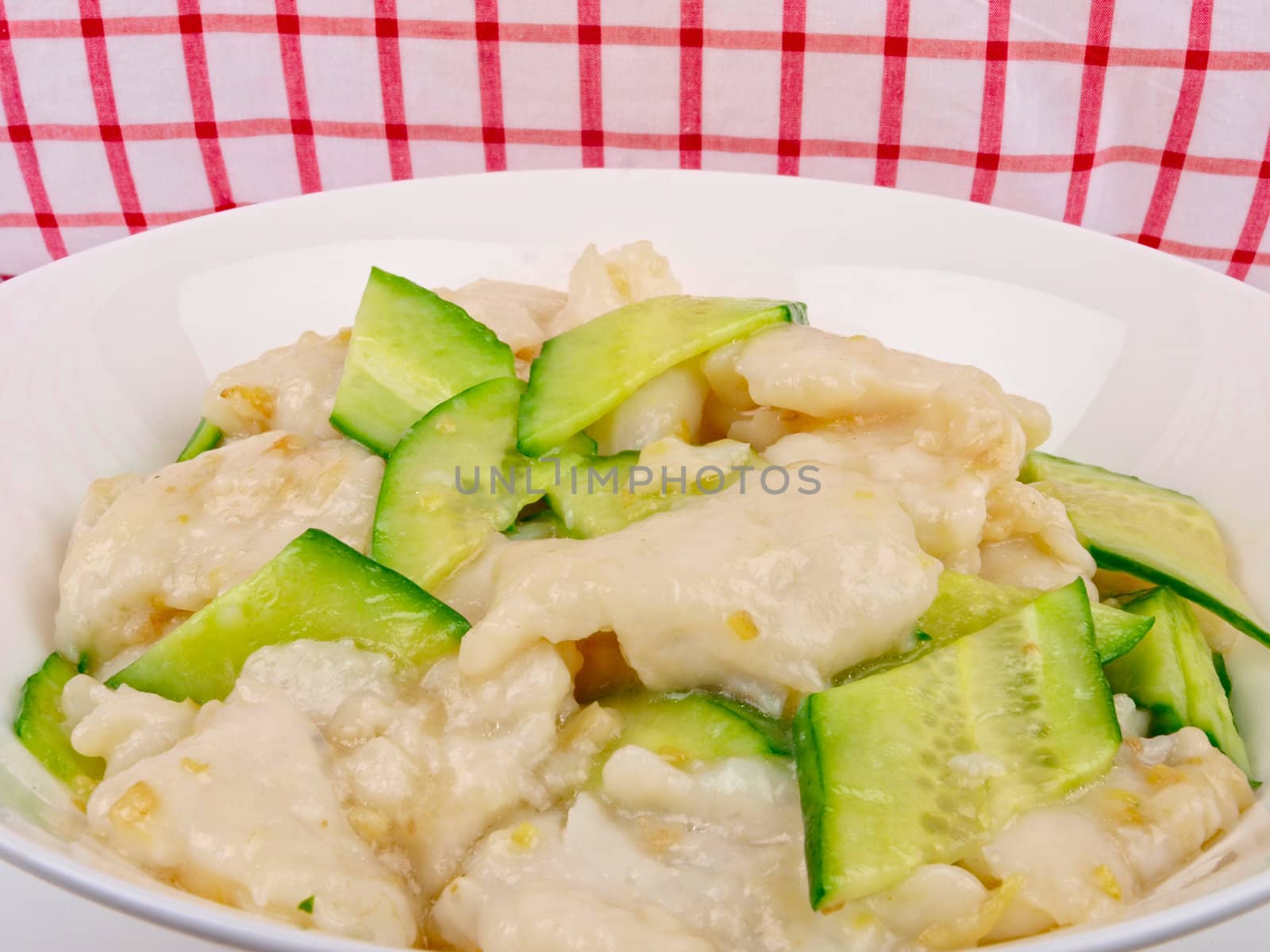 fried white fish with cucumber. Close up