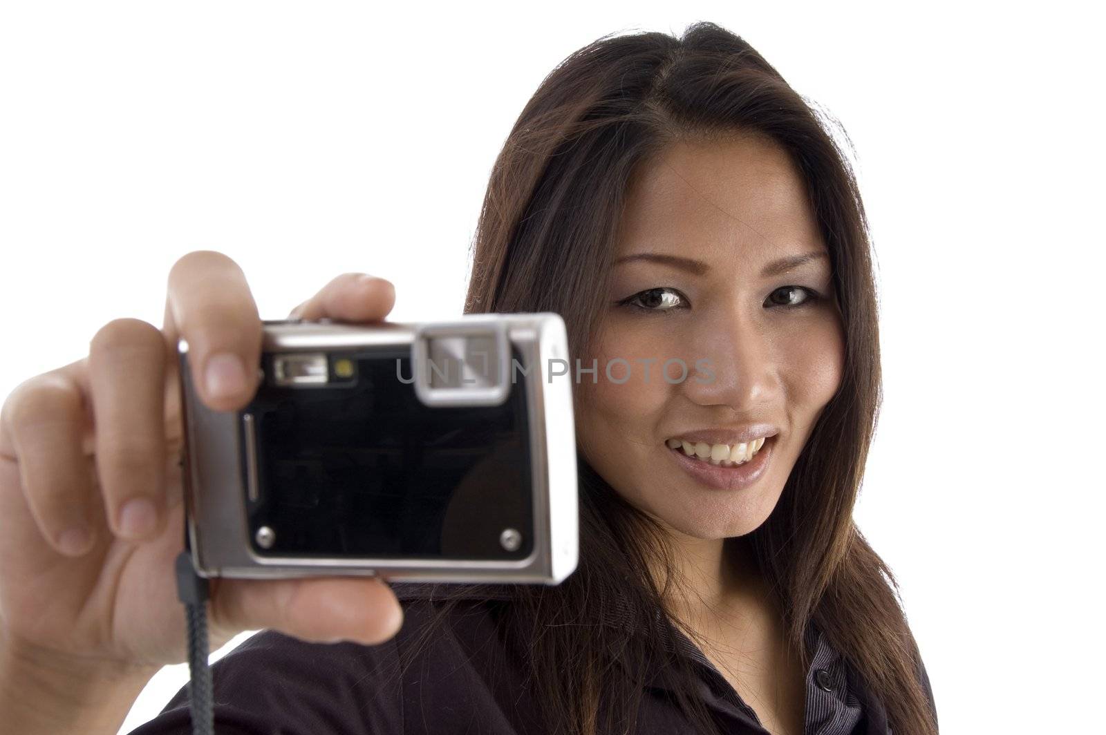 smiling female showing camera against white background