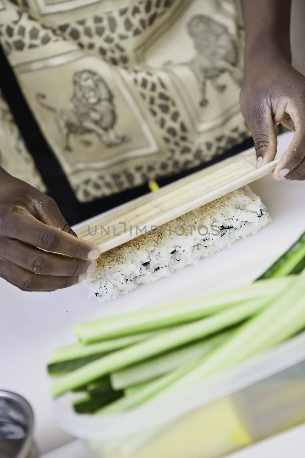 an african sushi checf in action preparing a sushi dish