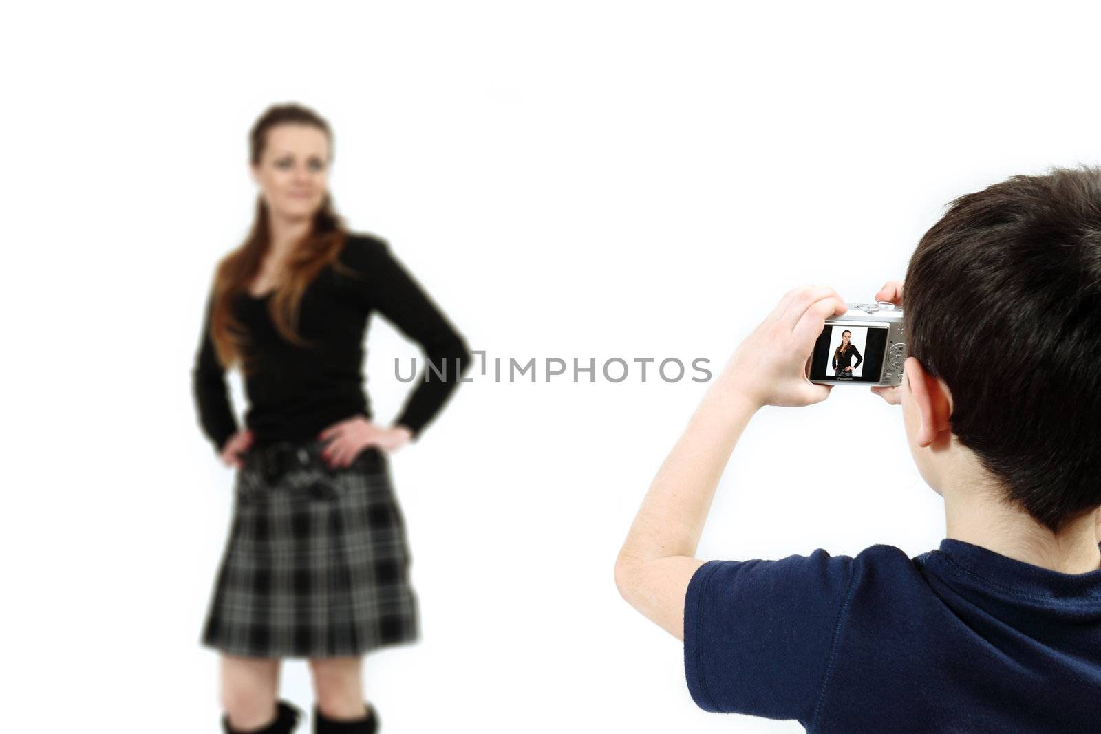 Young boy with digital camera prepare for shooting mother