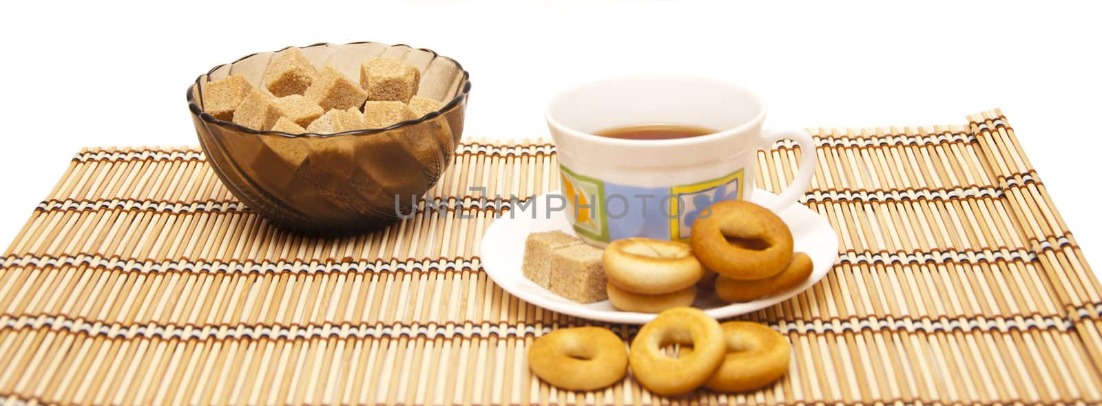 Cup of tea with steering-wheels on straw rug