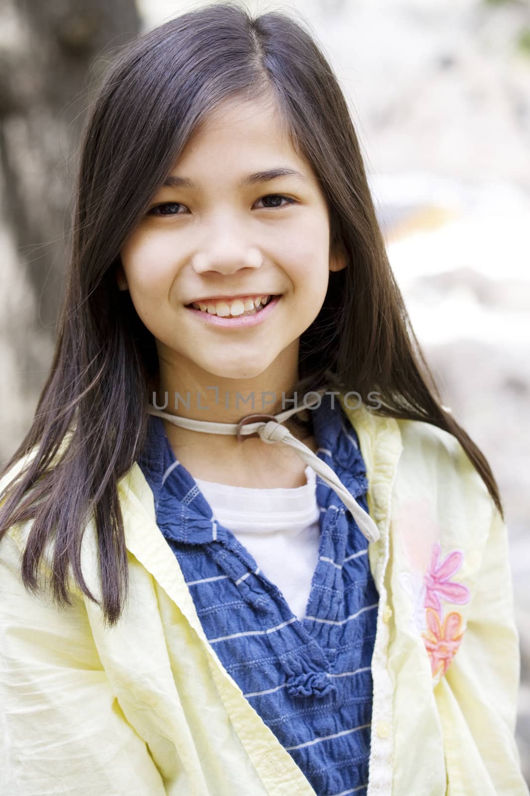 Beautiful little girl outdoors smiling