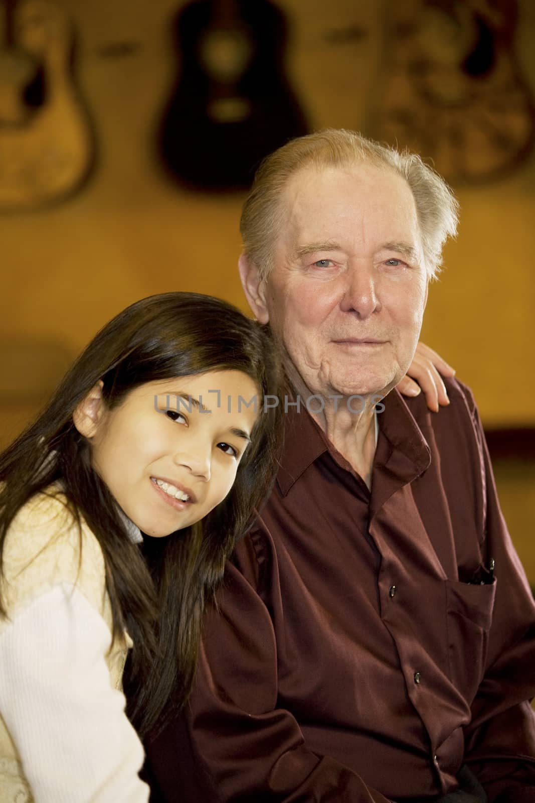 Elderly man sitting with granddaughter