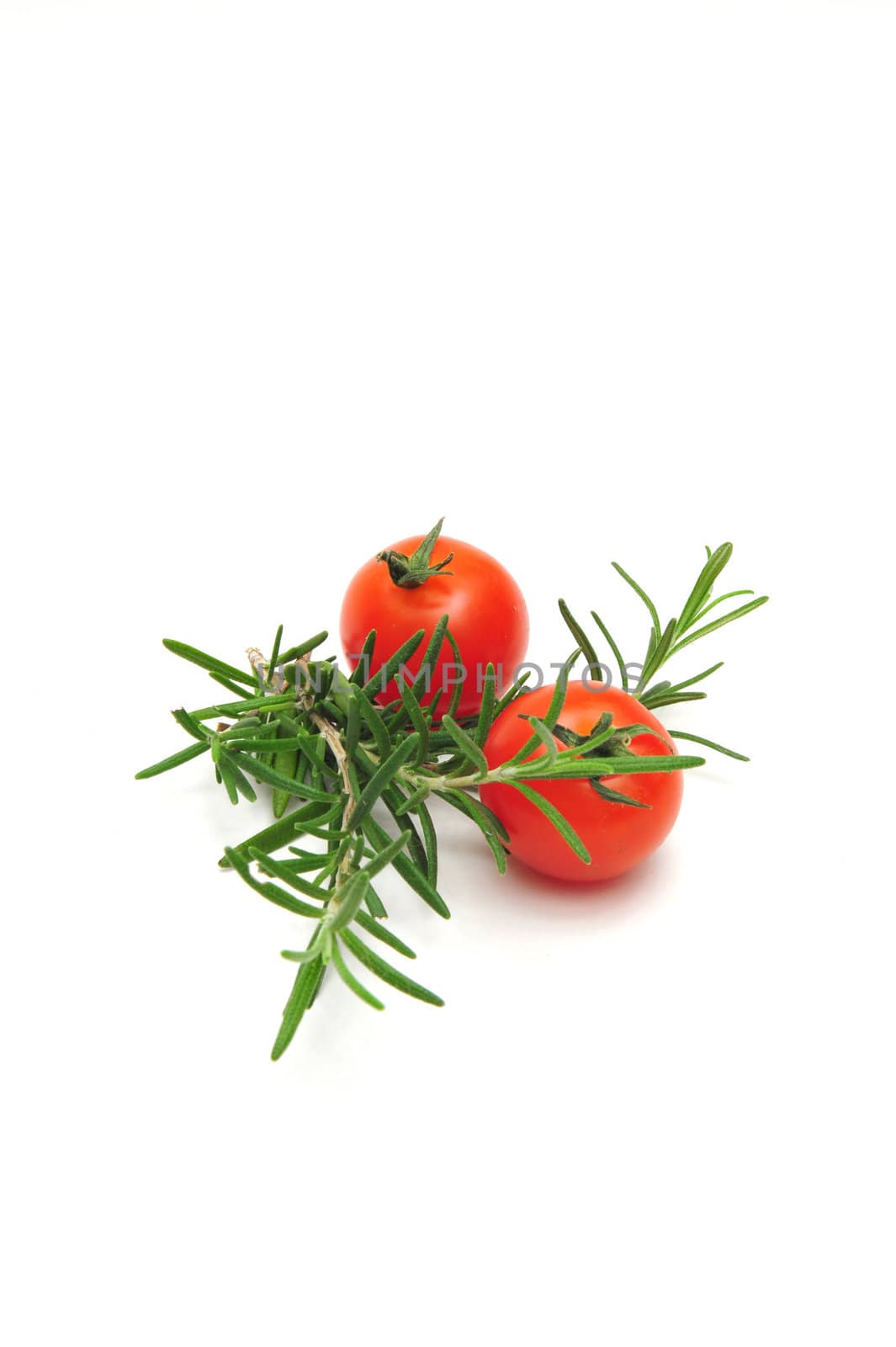 Two Cherry Tomatoes and Thyme branches on a light colored background