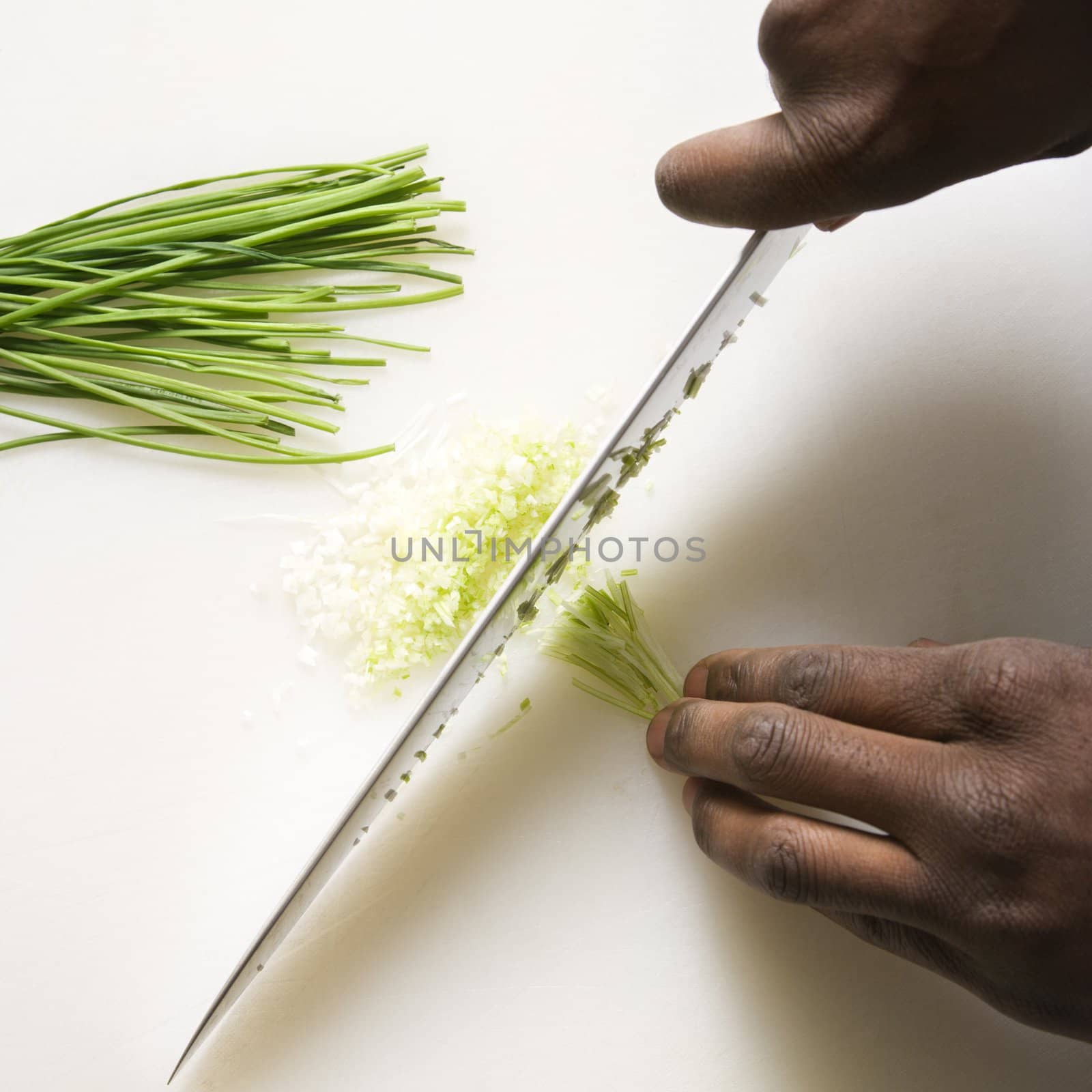 Knife chopping chives. by iofoto