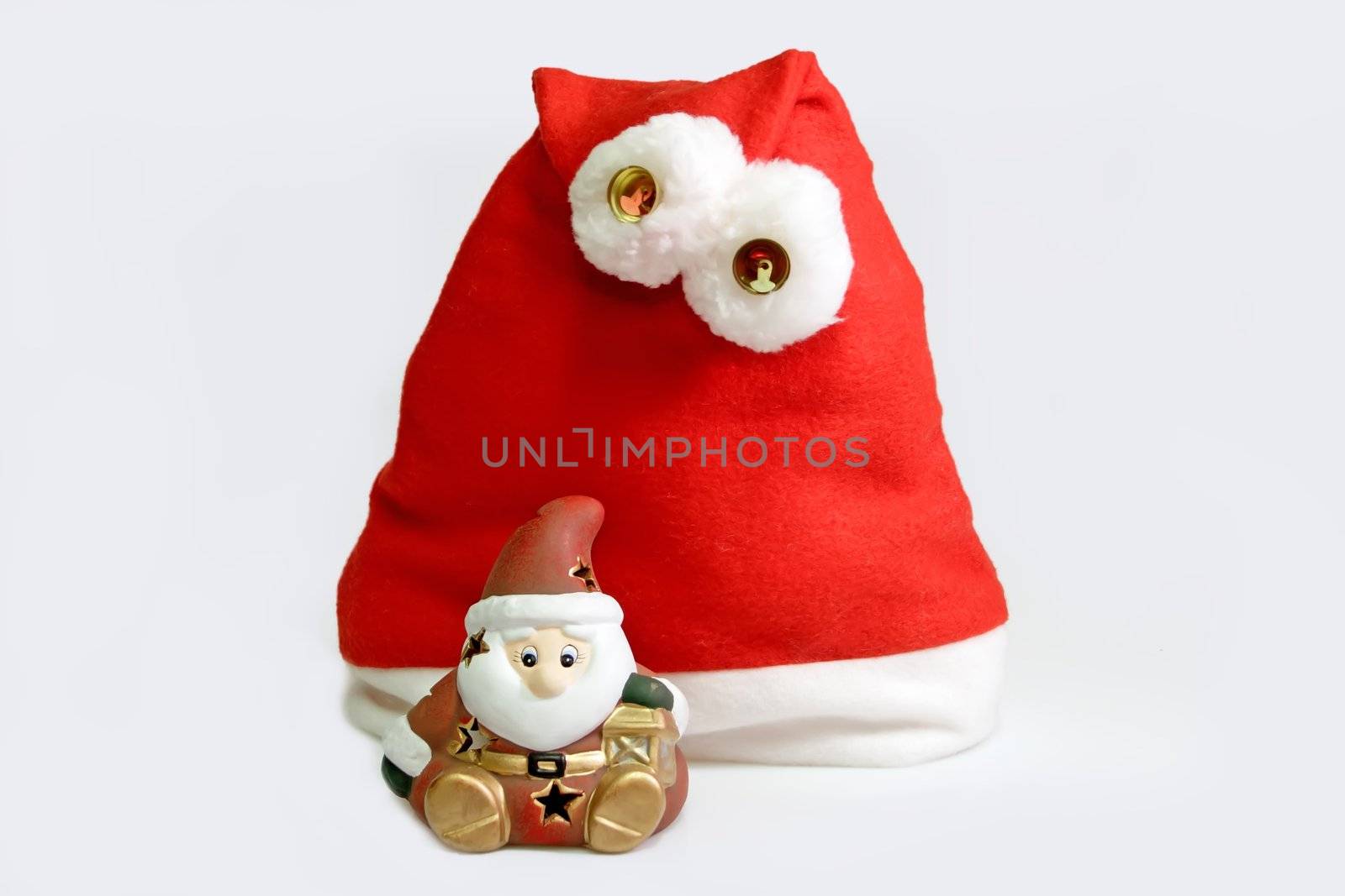 Santa hat with santa claus figure on light background