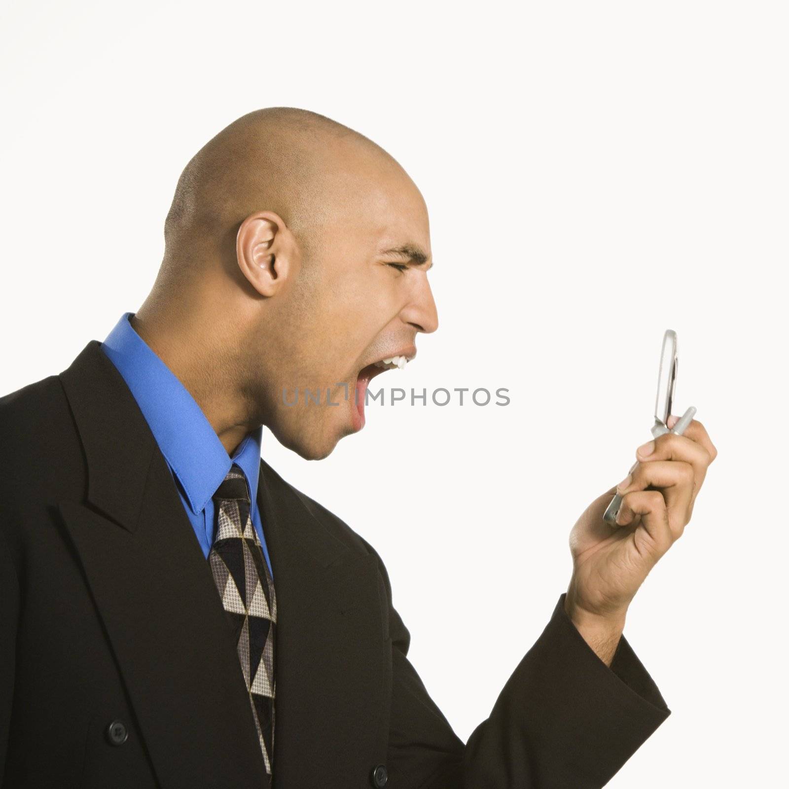 Man yelling at cellphone. by iofoto