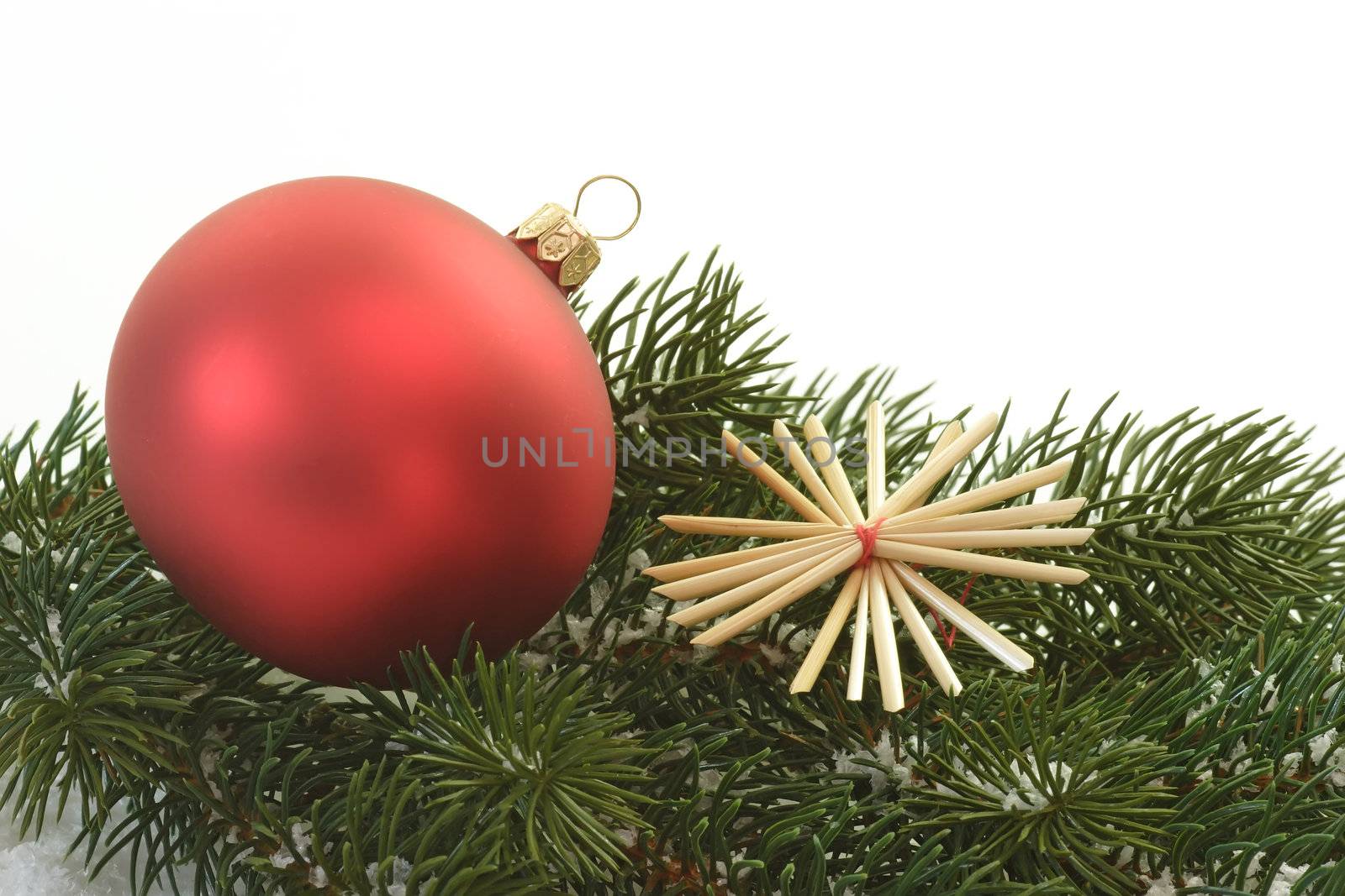 Red christmas tree ball lying on a fir branch