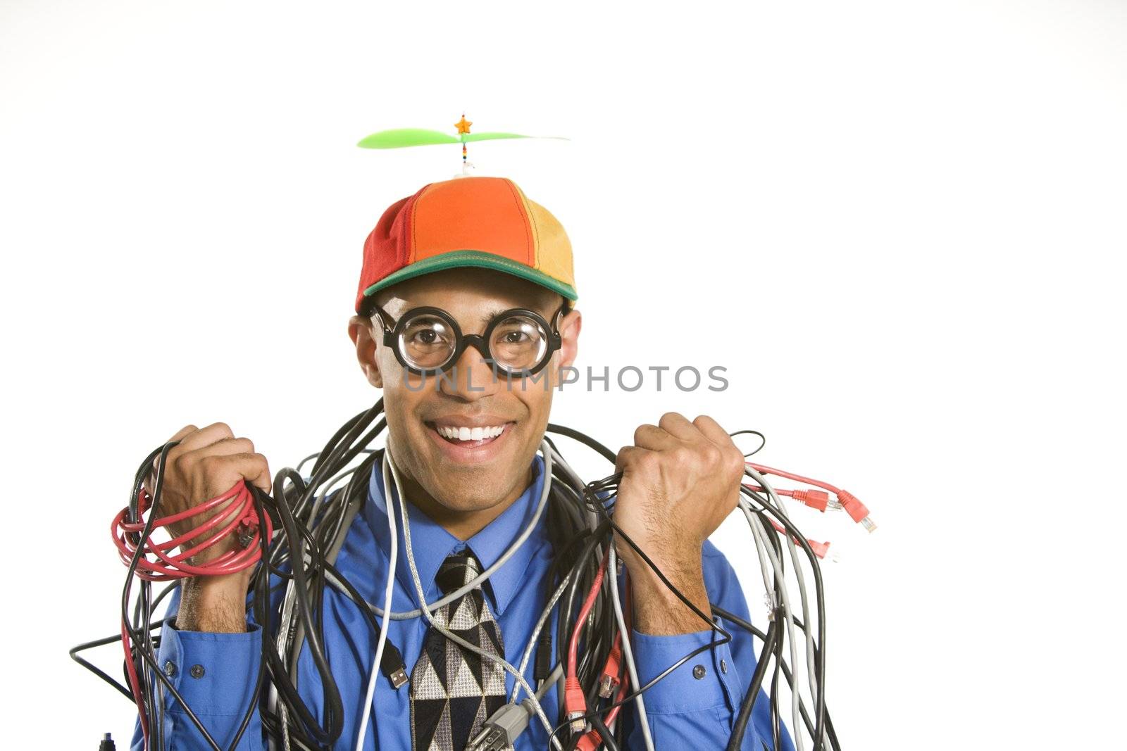 African American businessman wrapped in computer cables wearing nerd hat and glasses.