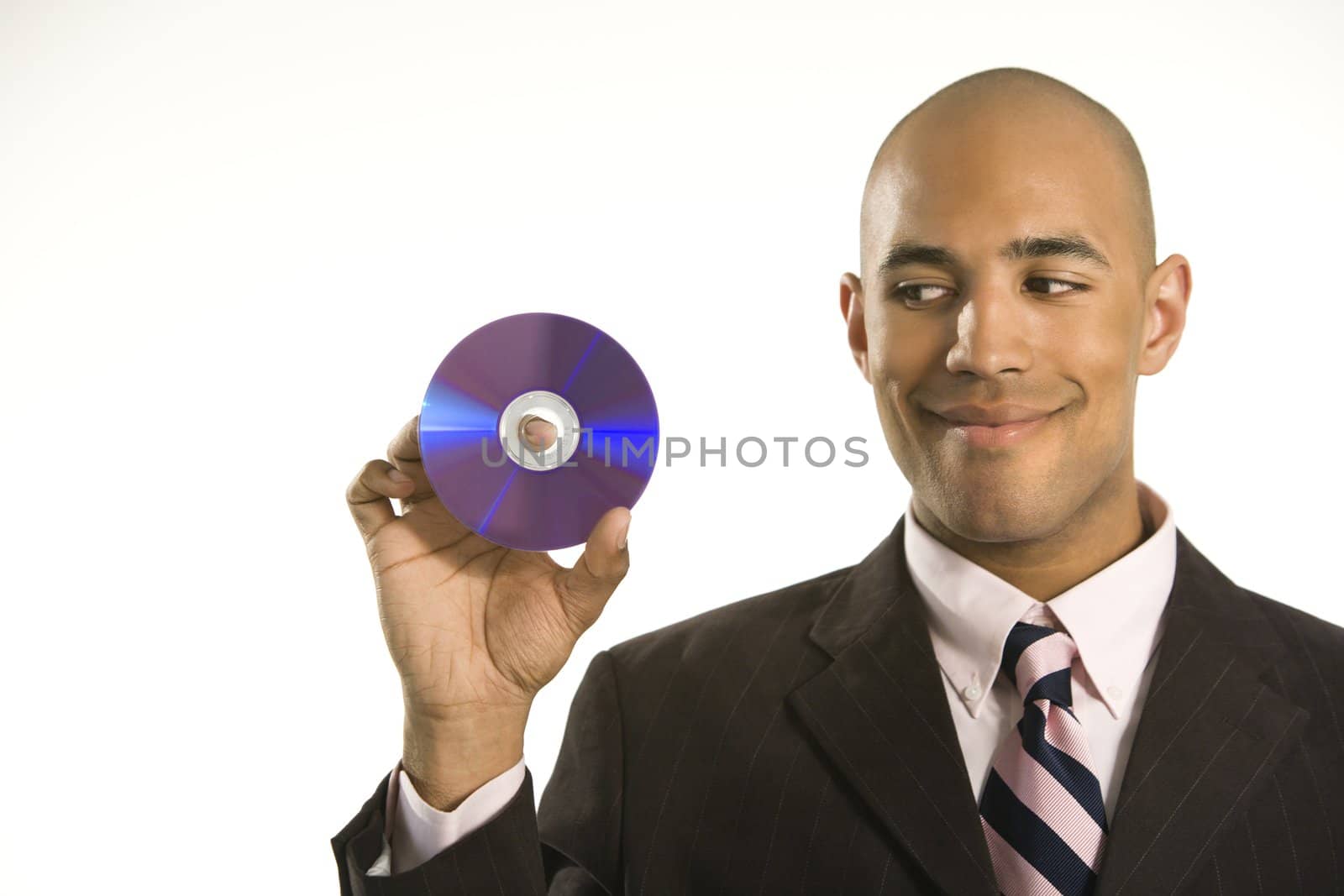 African American man smiling holding out compact disc.
