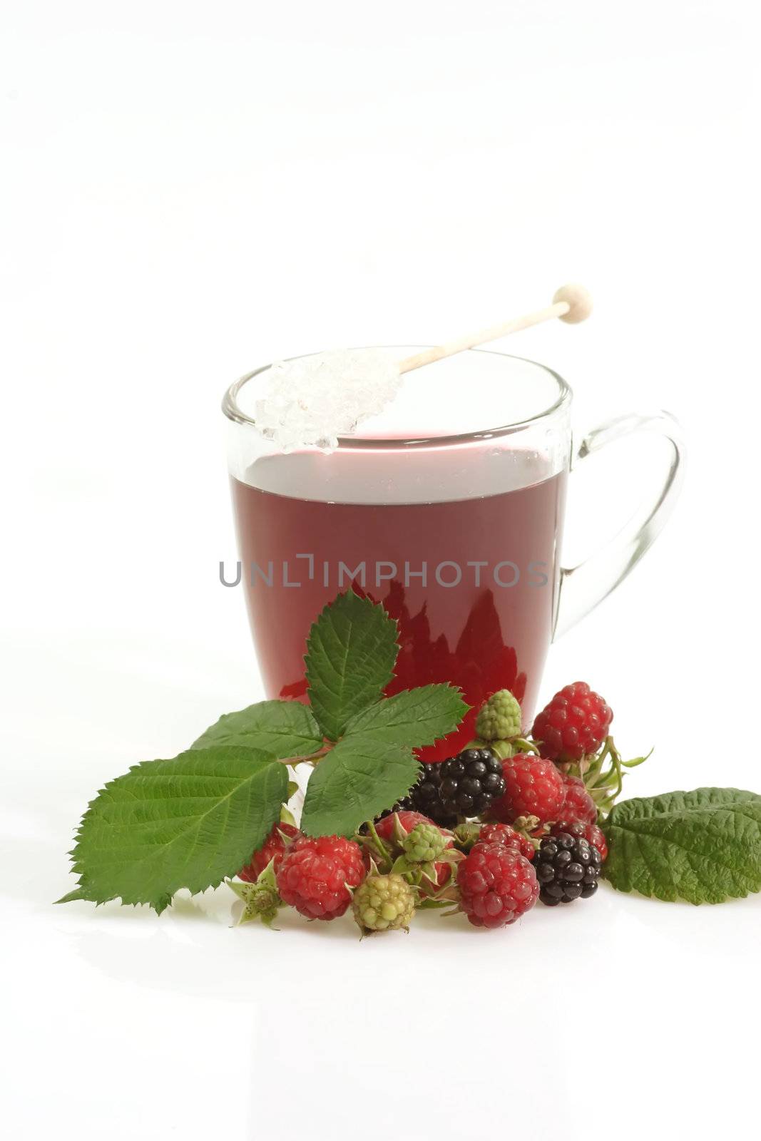 A glass of red fruit tea on bright background