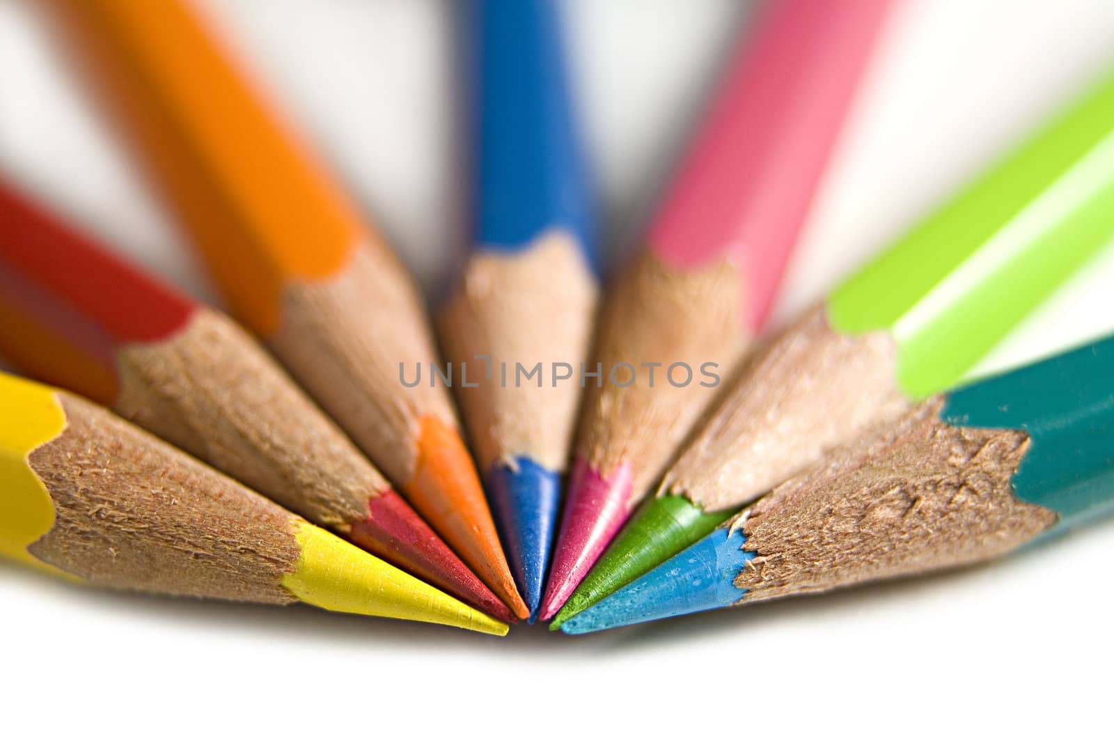 A macro shot of seven bright coloured pencils.