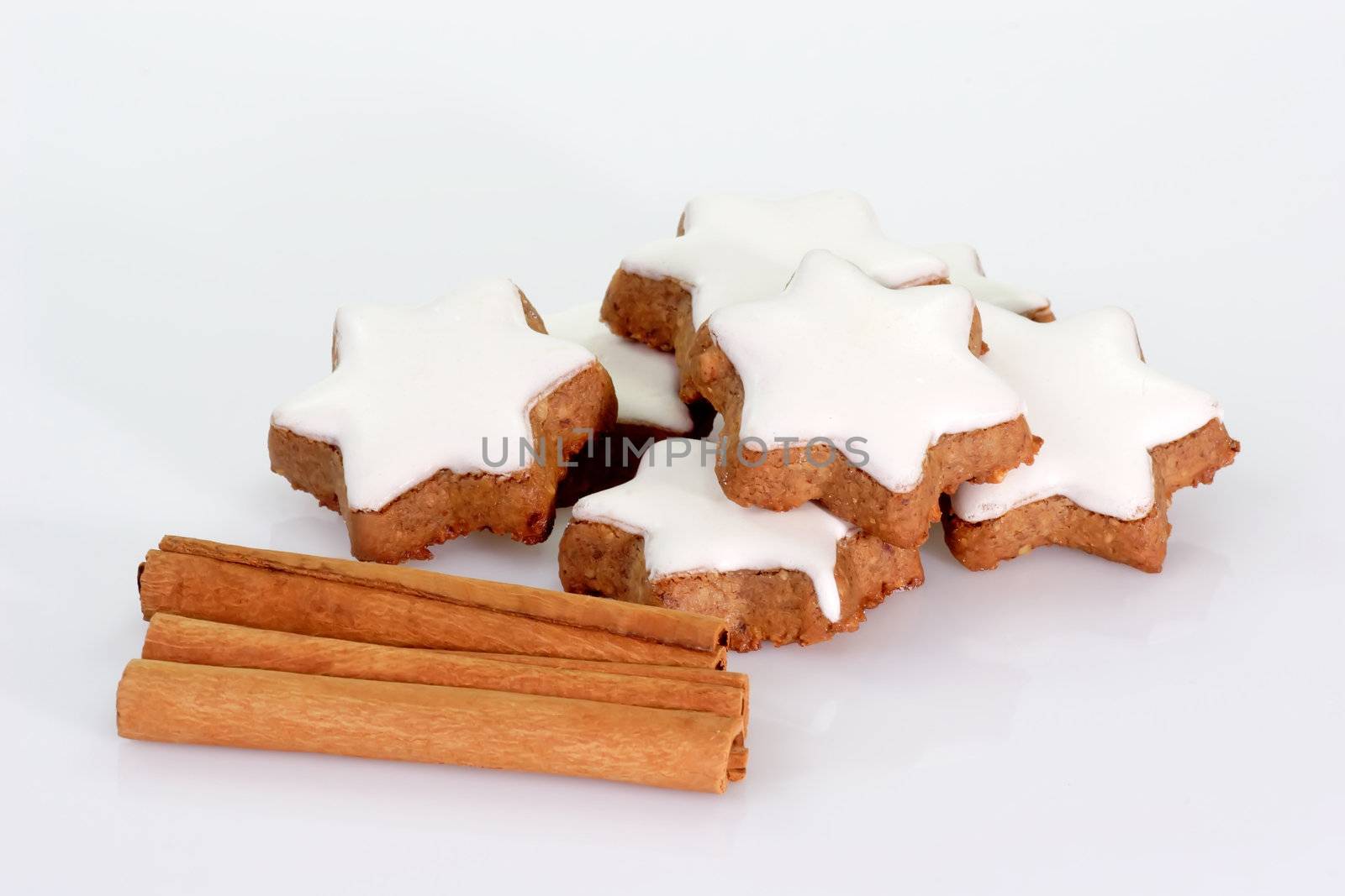 Christmas cookies with cinnamon sticks on bright background