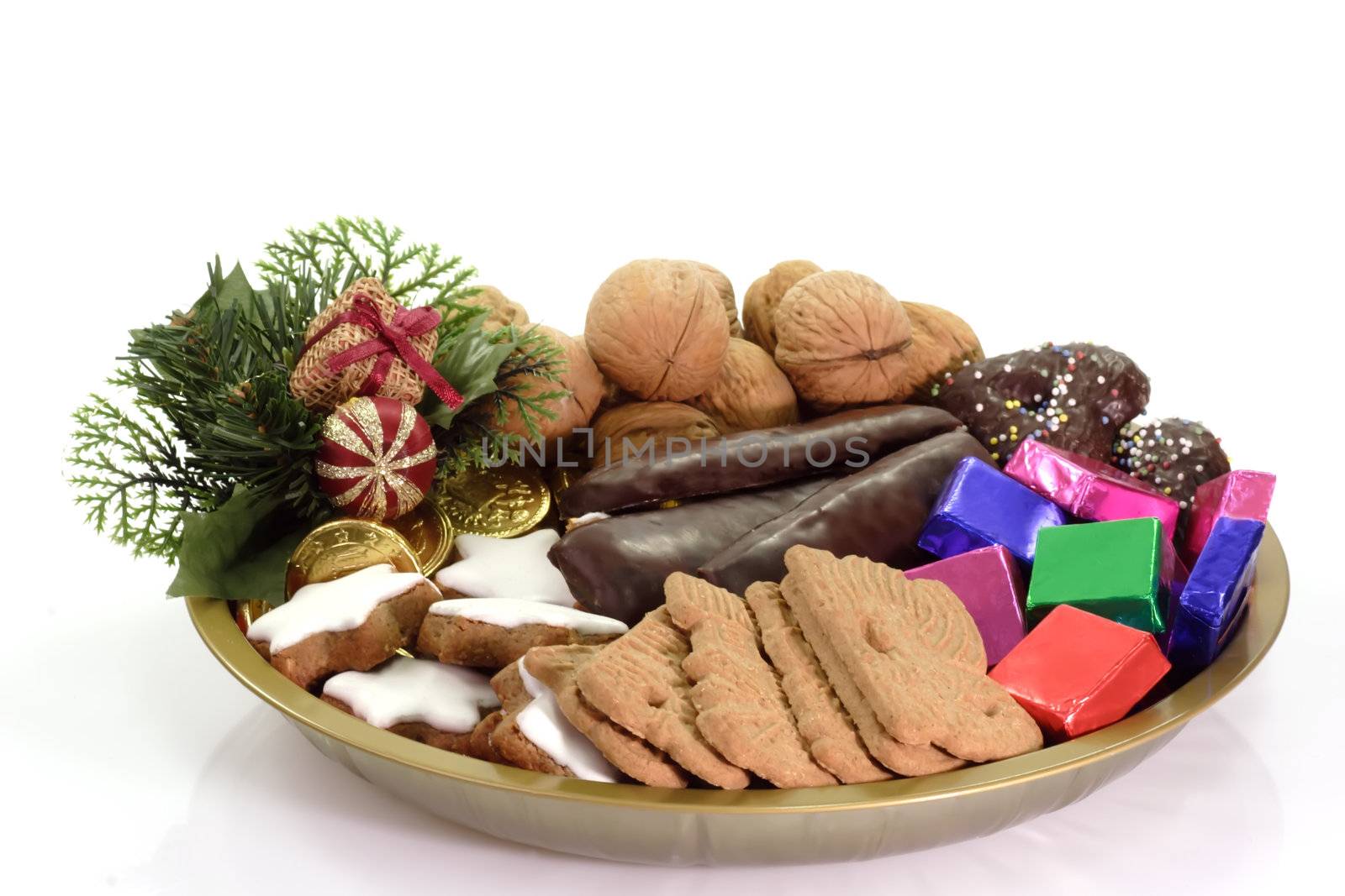 Plate of different christmas goodies on bright background