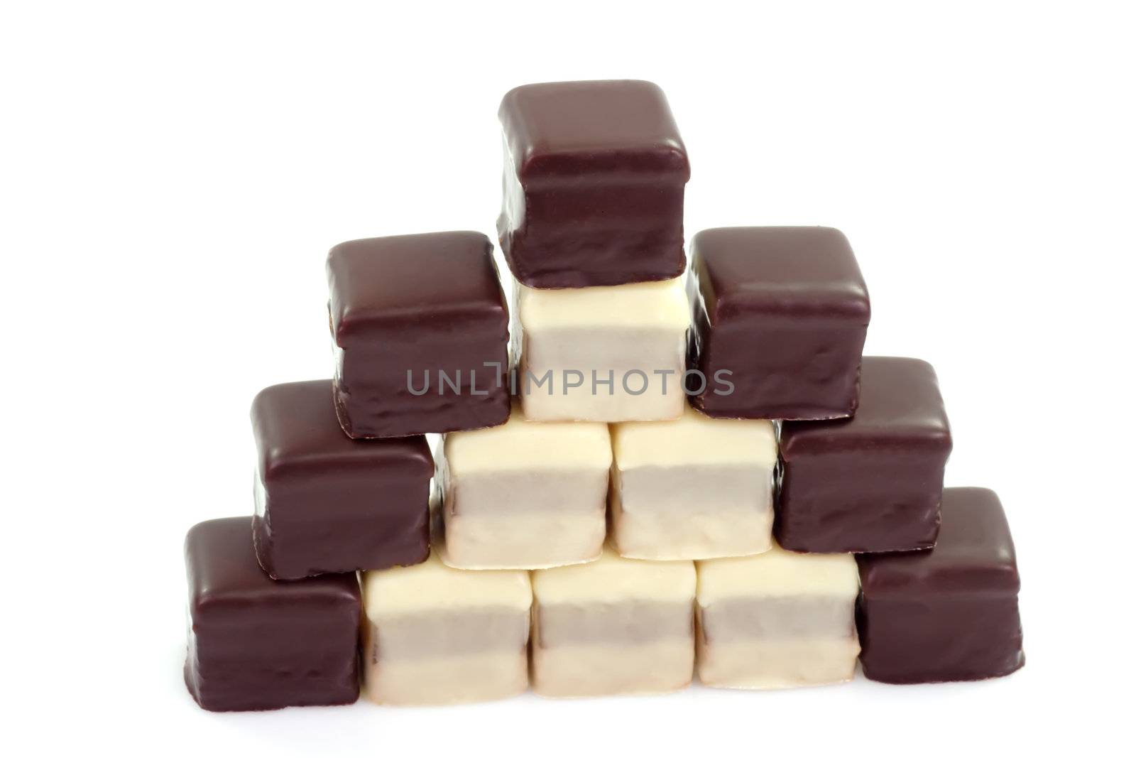 Pyramid of sweet chcolate confectionary on bright background