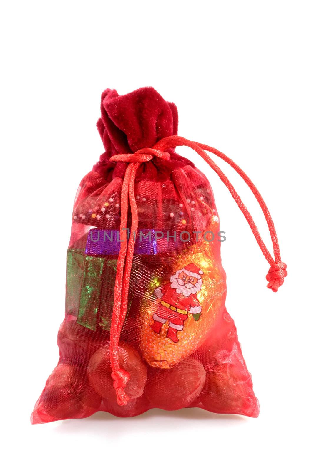 Red santa sack of christmas sweets on bright background