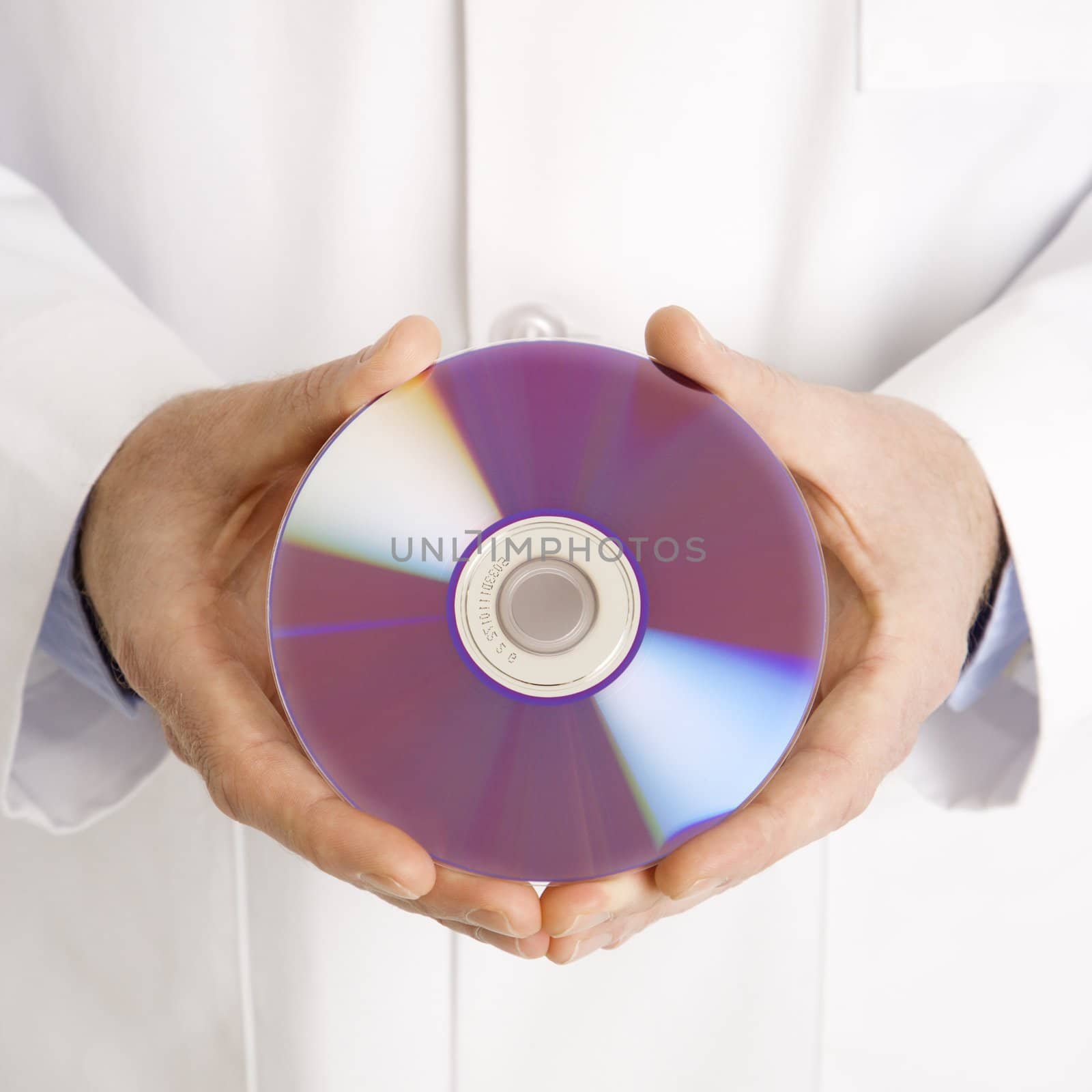 Doctor holding compact disc. by iofoto