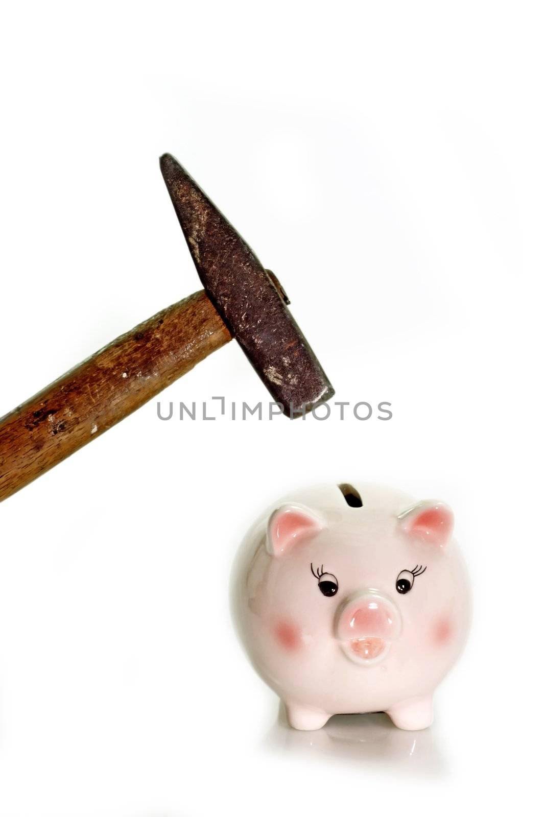 Pink piggy bank with hammer on white background