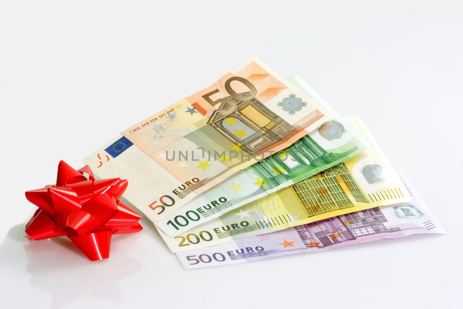Red ribbon with European bank notes on light background