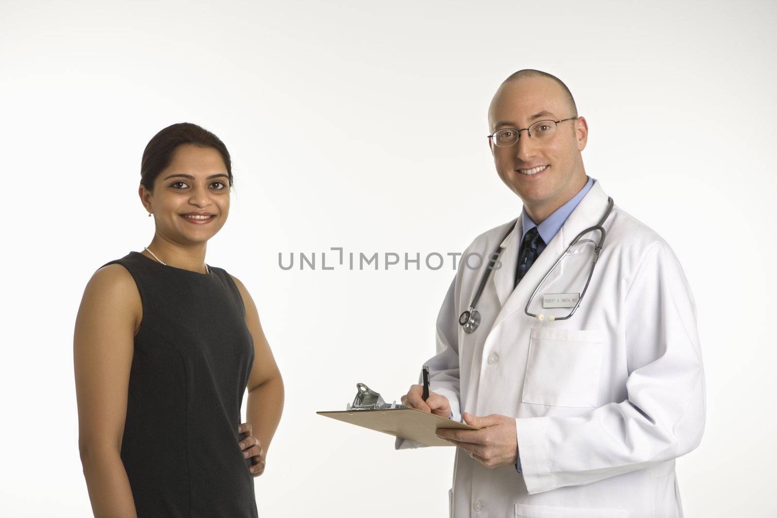 Caucasian mid adult male physician talking with Indian woman patient.