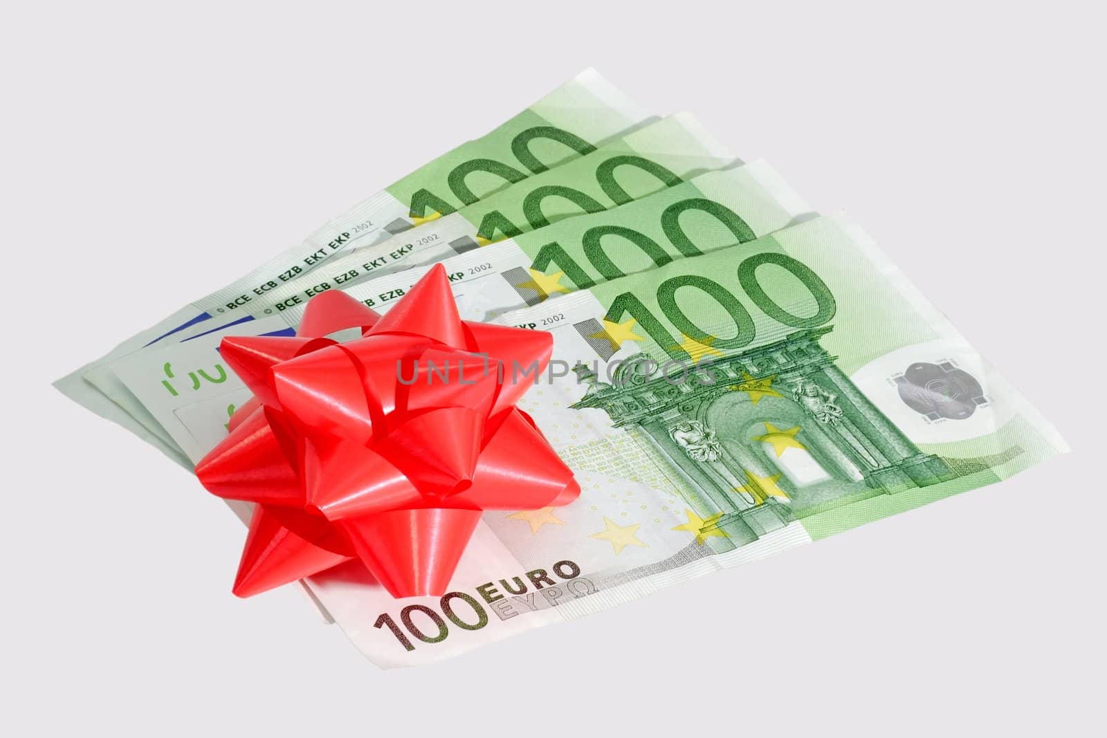 Five onehundred Euro notes with red bow - isolated