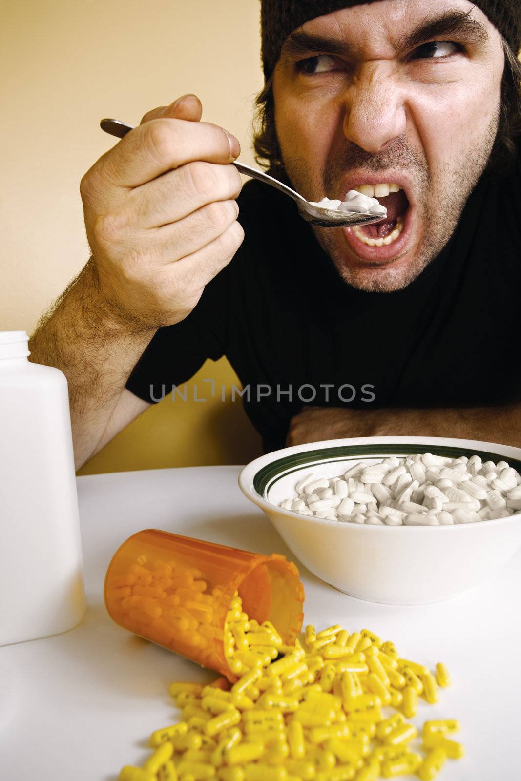 A man feeding himself medication with a spoon. Metaphor for addiction, dependency, etc.
