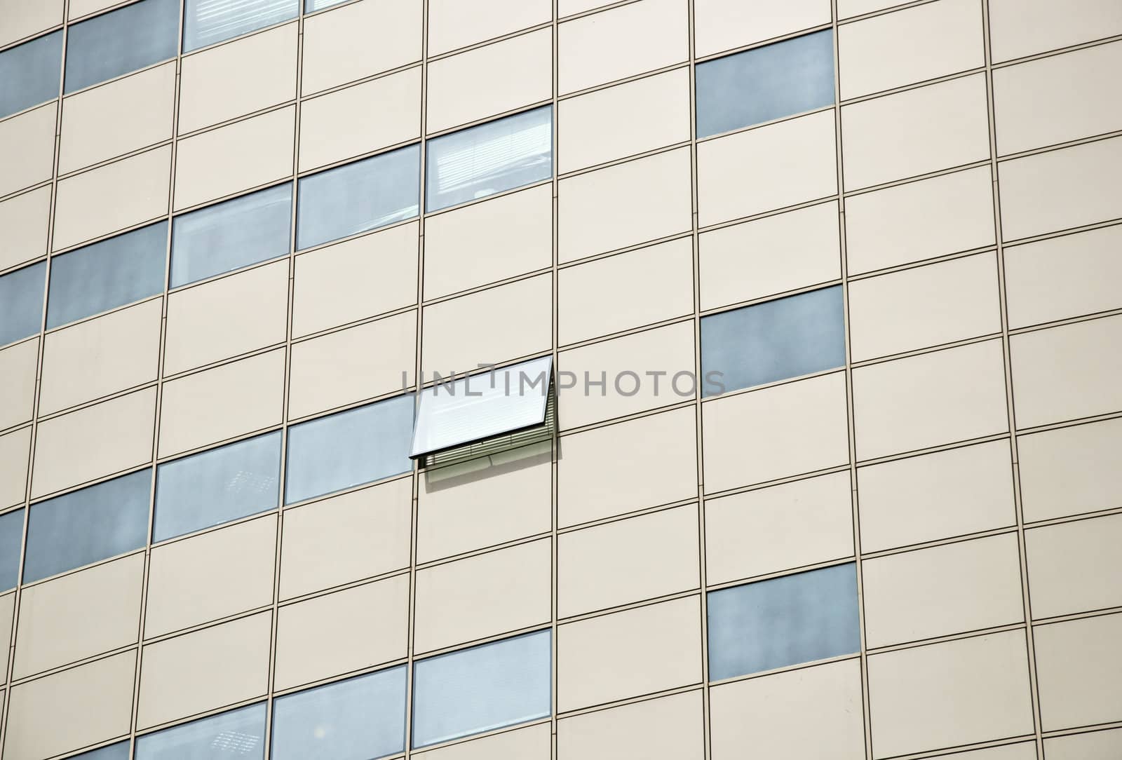 Detail of the facade office building. Aluminum panel and stained glass. One window is open. Outdoor. Close up.