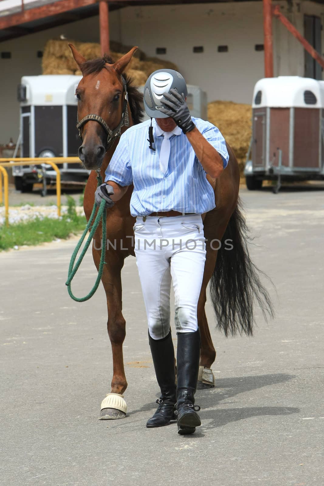  KYIV, UKRAINE - JULY 18:Jockey with him brown horse during a Open Equestrian Cup on July 18, 2008 in Kyiv, Ukraine