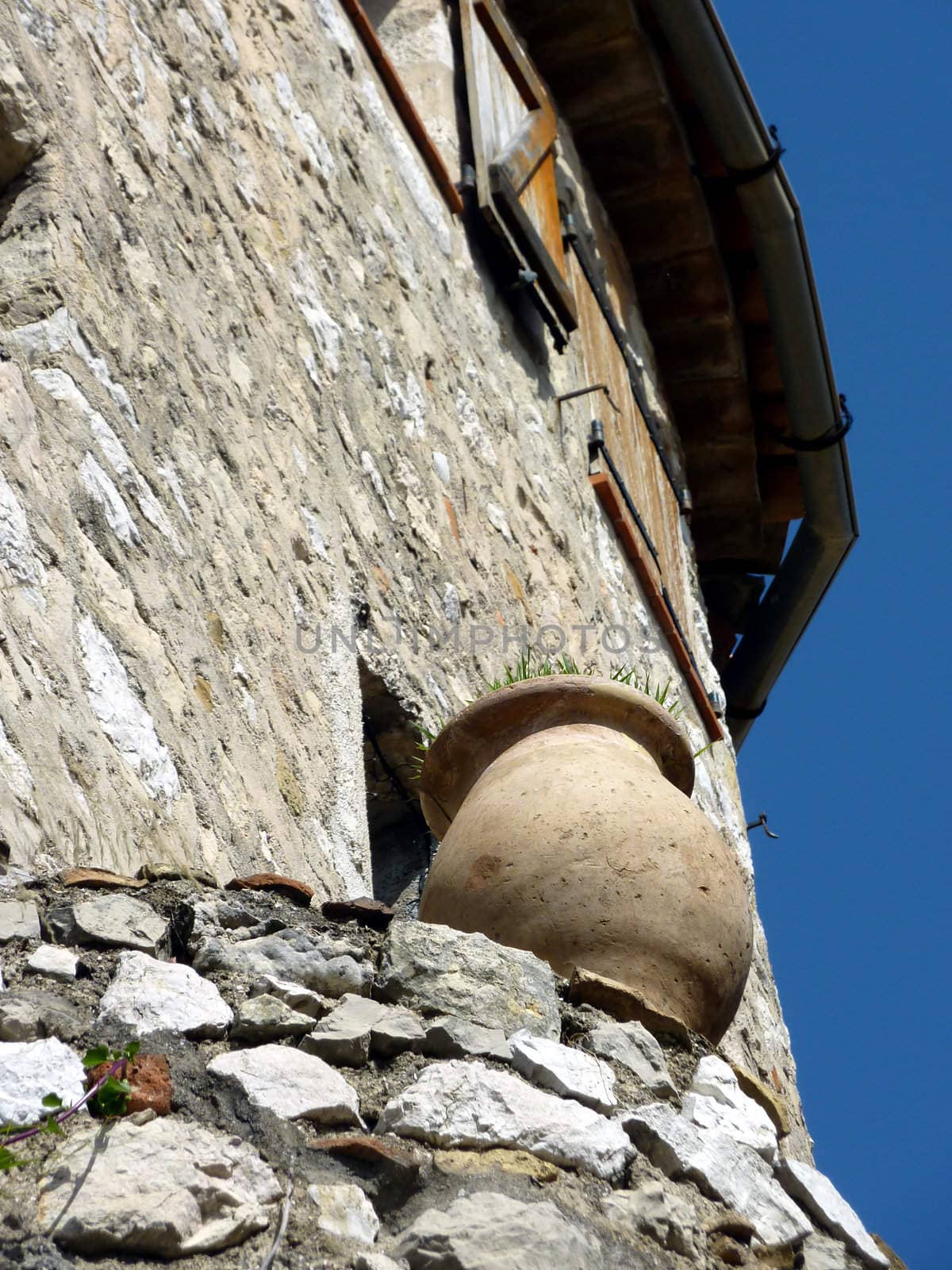 Brown pottery standing on the wall of a house in Eze historical village, south of France