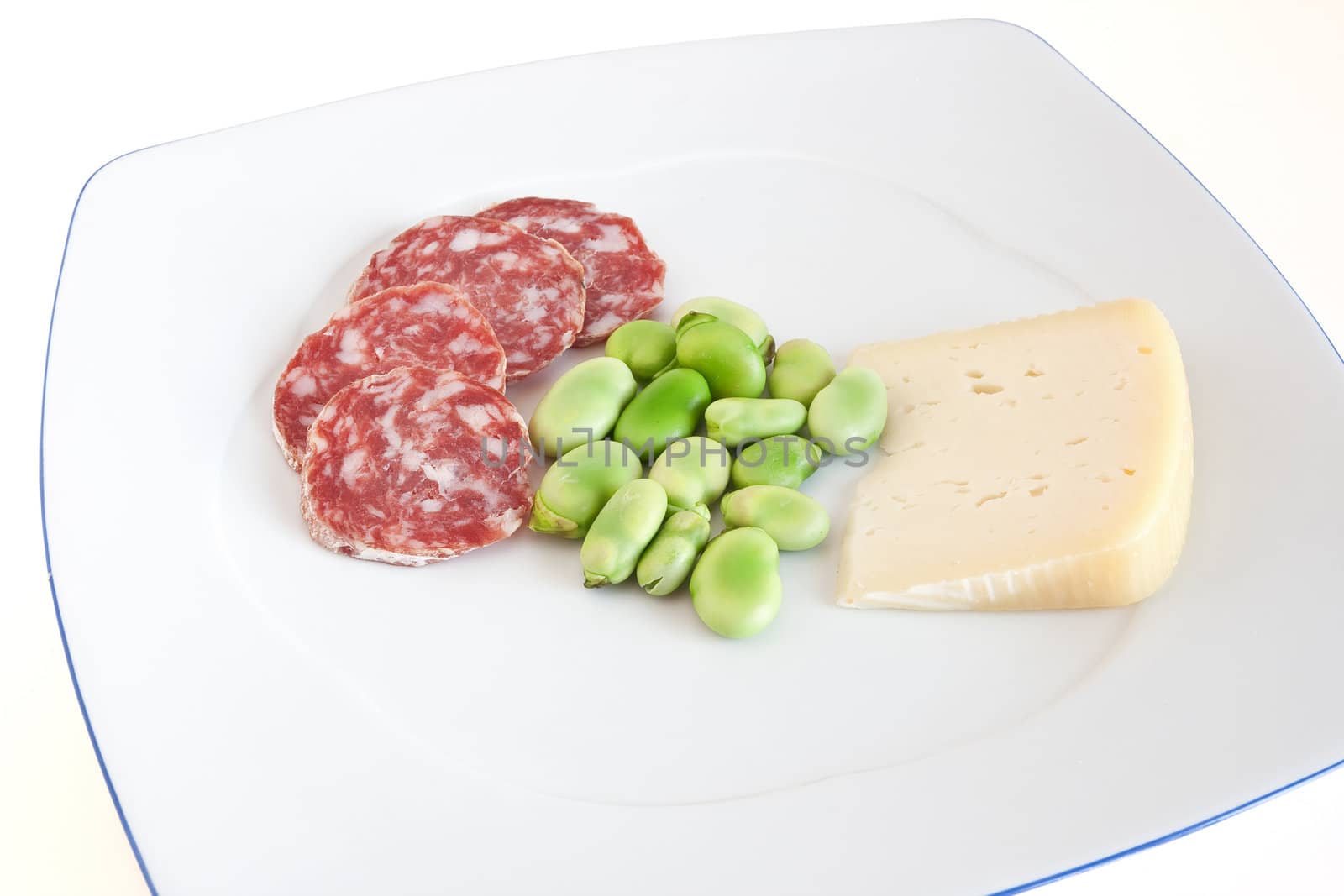 broad beans with pecorino cheese and salami slices on a white plate isolated with clipping path