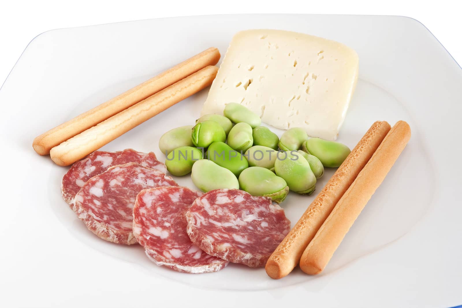 broad beans with pecorino cheese breadsticks and salami slices on a white plate isolated with clipping path