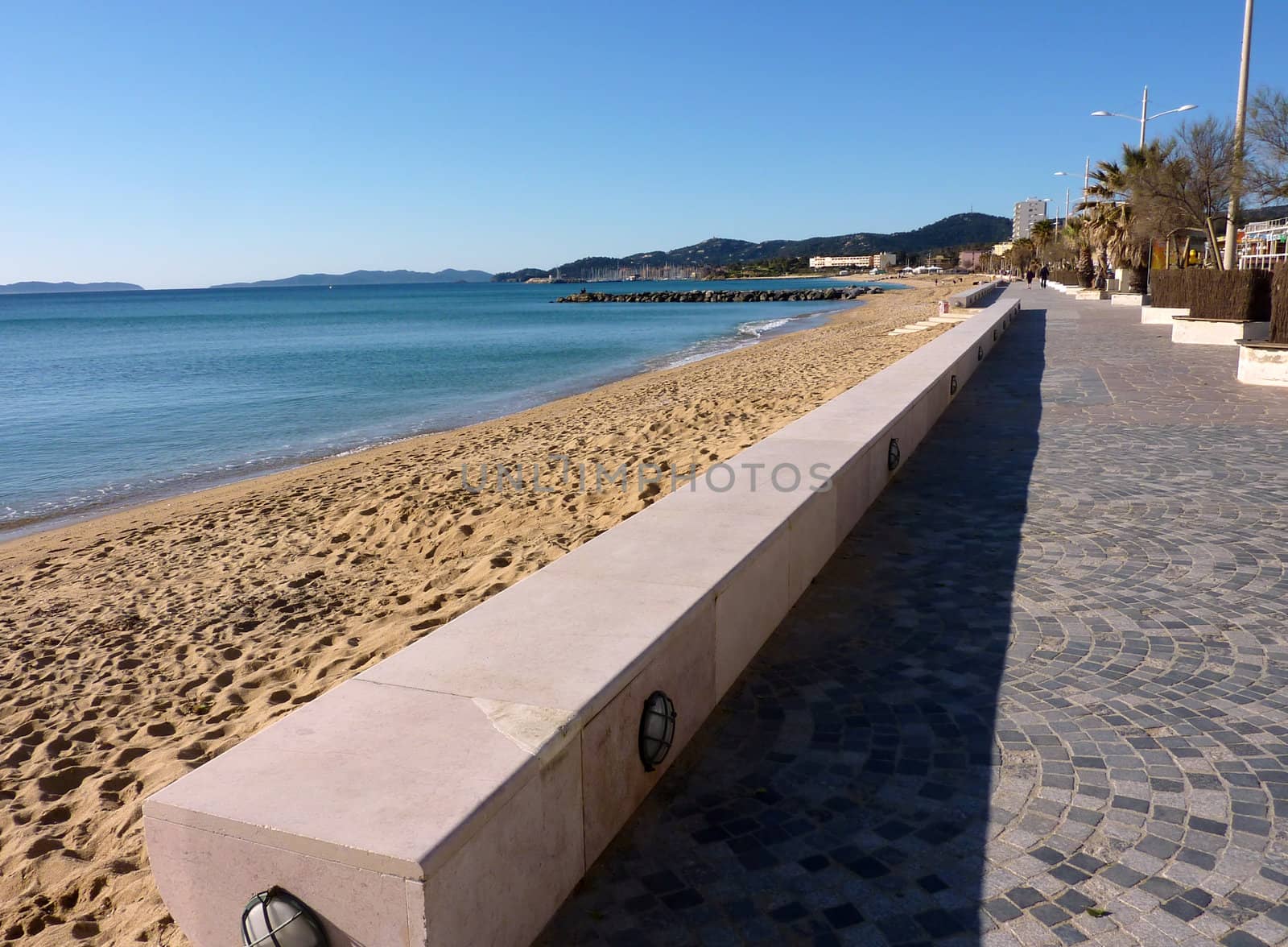 Seaside with sand and walkway at Lavandou, south of France, by beautiful weather
